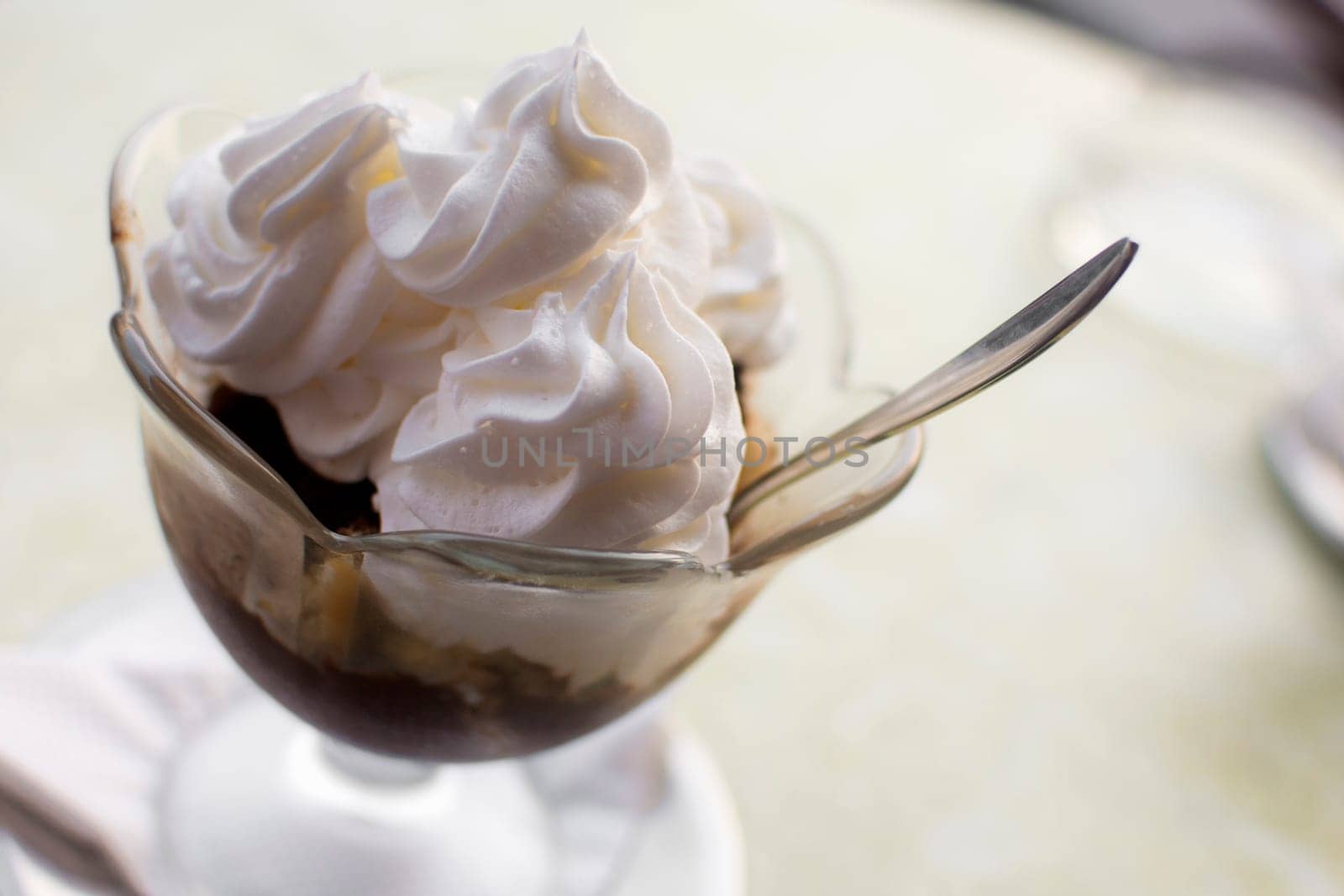 Traditional Hungarian dessert, somloi galuska, with whipped cream.