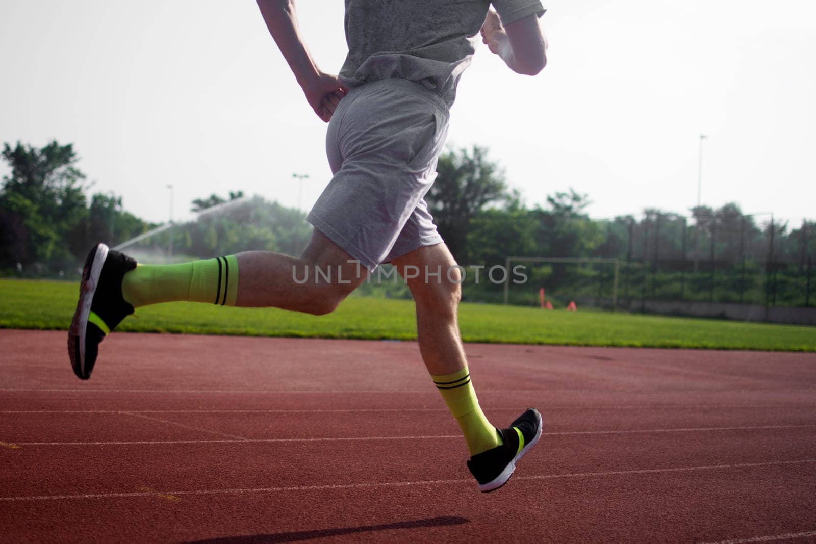 The athlete is running in the stadium.