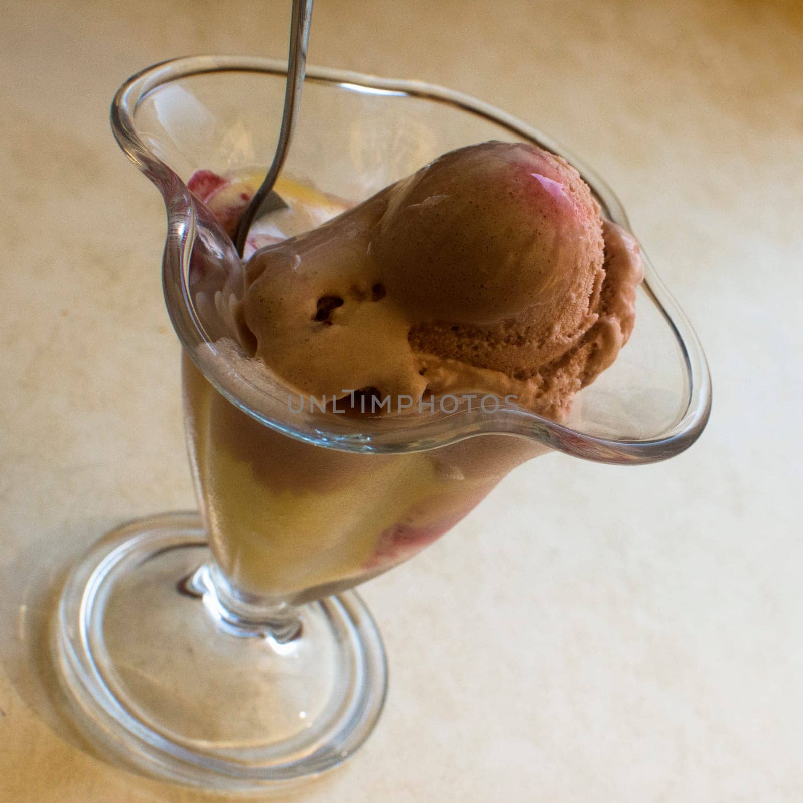 The ice cream is in glass on table.