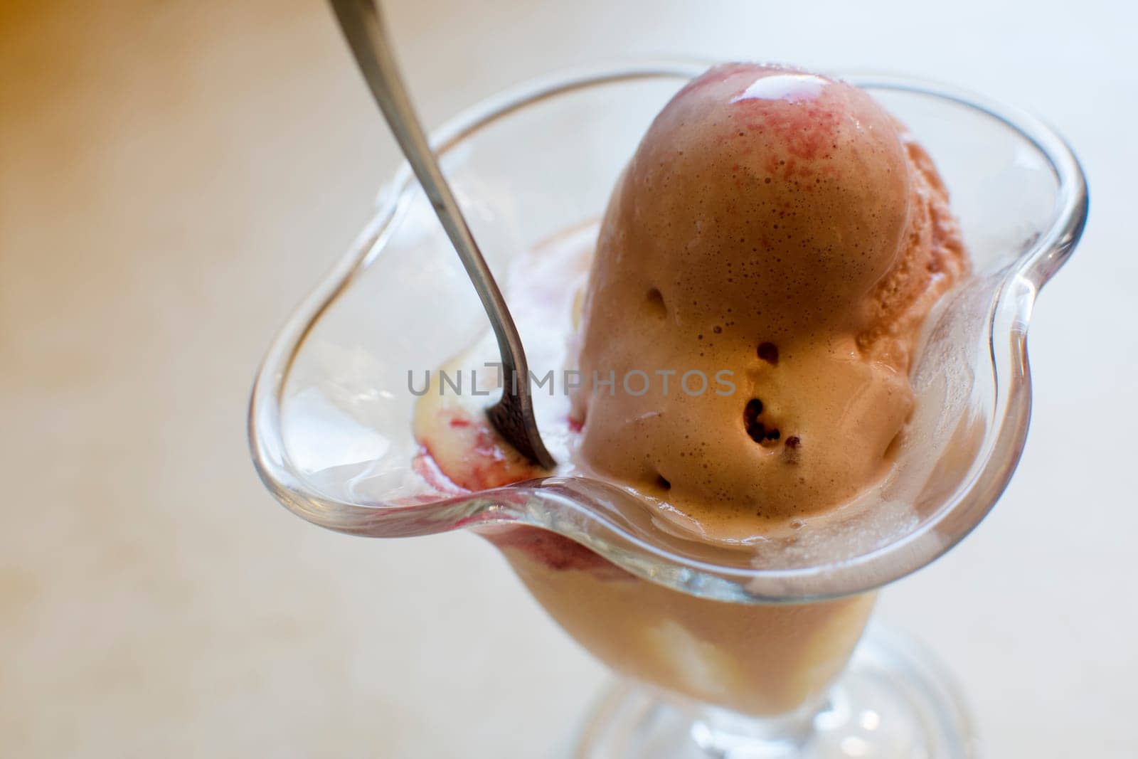 The ice cream in glass is on table.