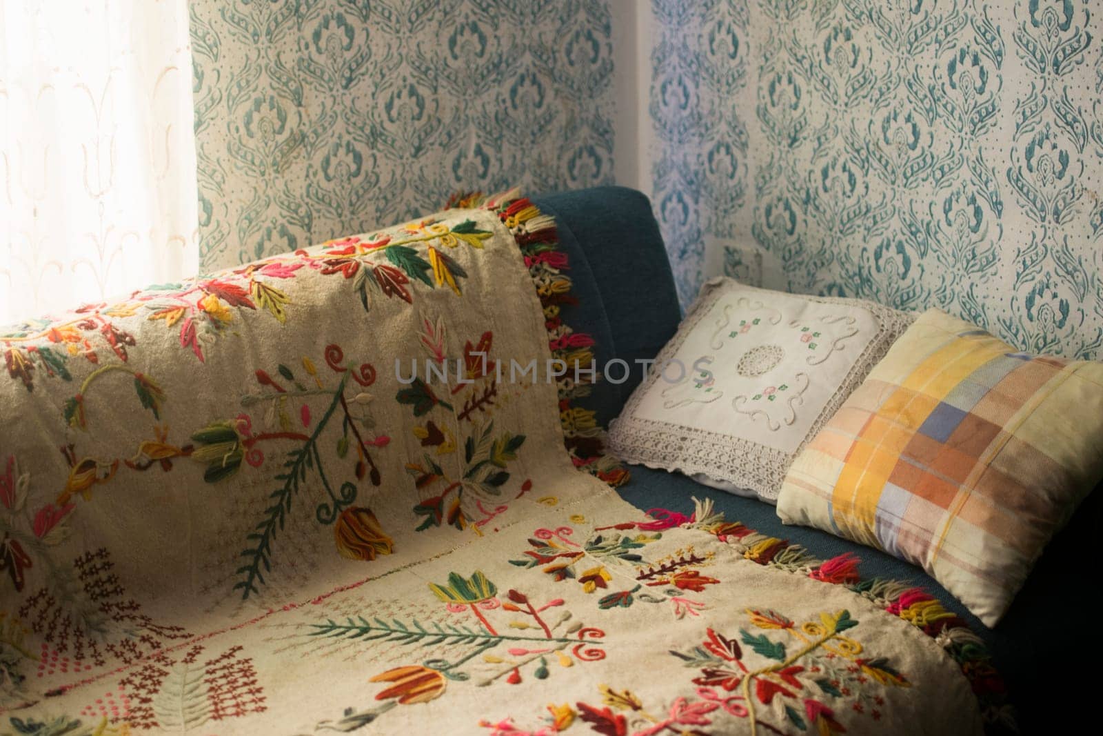 Old village room with bed and vintage patterns on the wall.