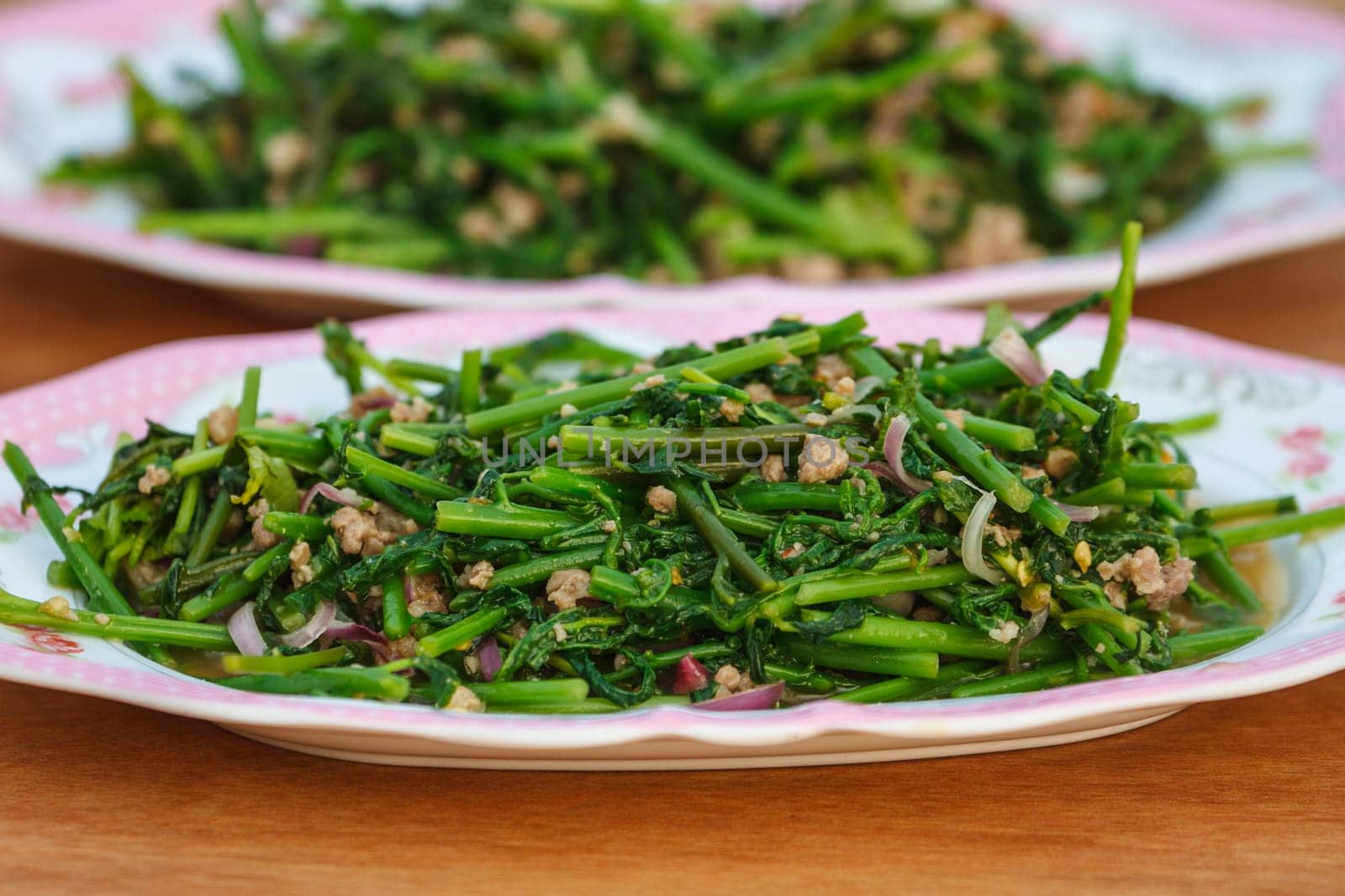 Vegetable fern spicy salad on wooden background