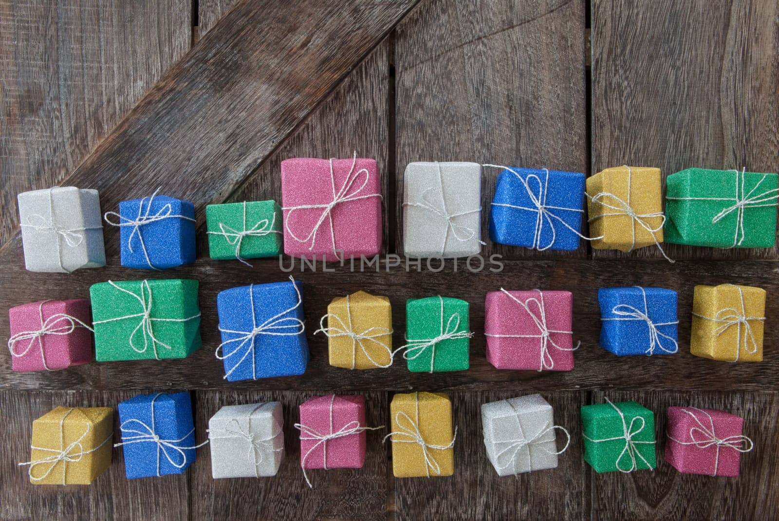 Small colorful gifts in glitter wrapping paper for Christmas