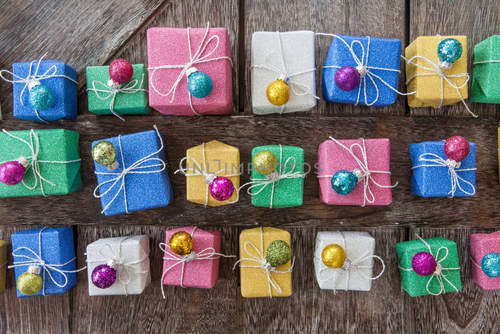 Small colorful gifts in glitter wrapping paper for Christmas