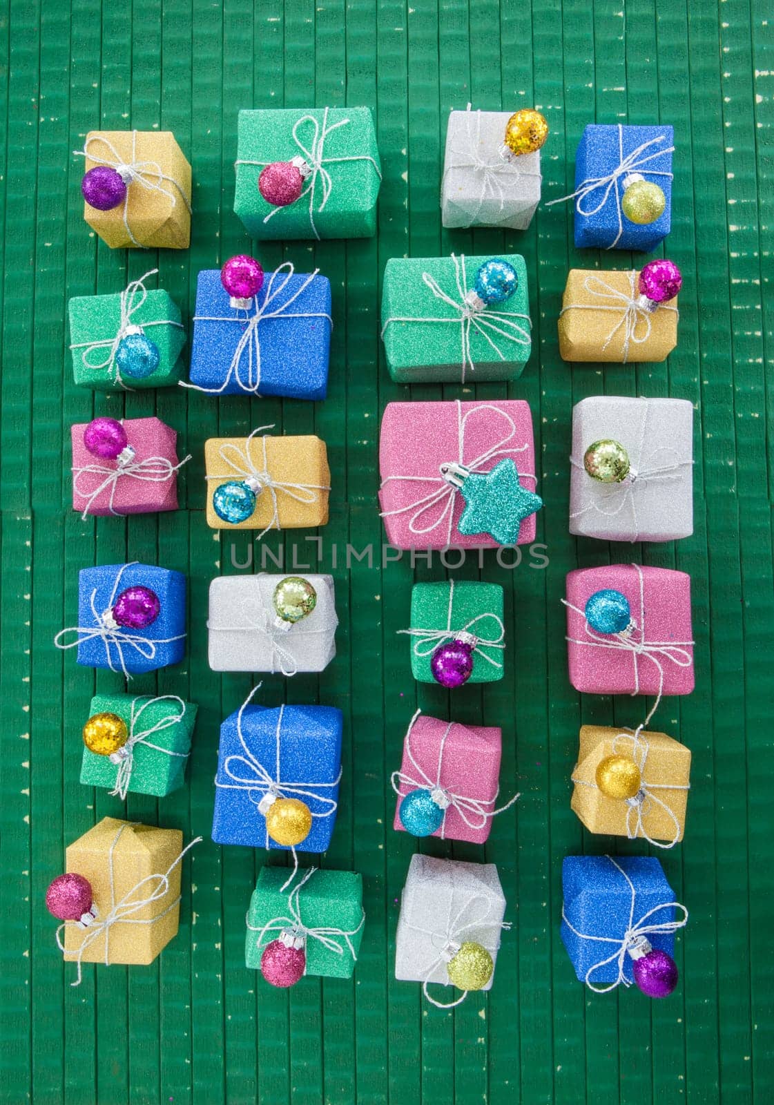 Small colorful gifts in glitter wrapping paper for Christmas