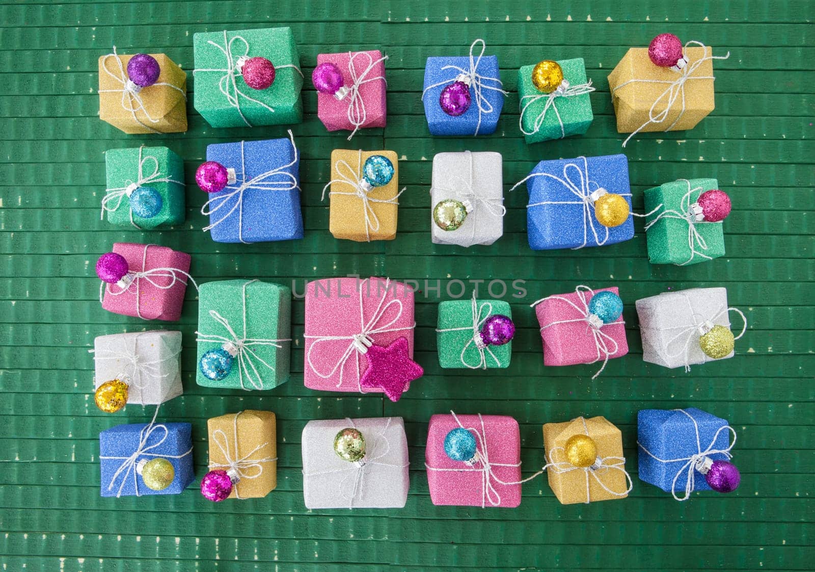Small colorful gifts in glitter wrapping paper for Christmas