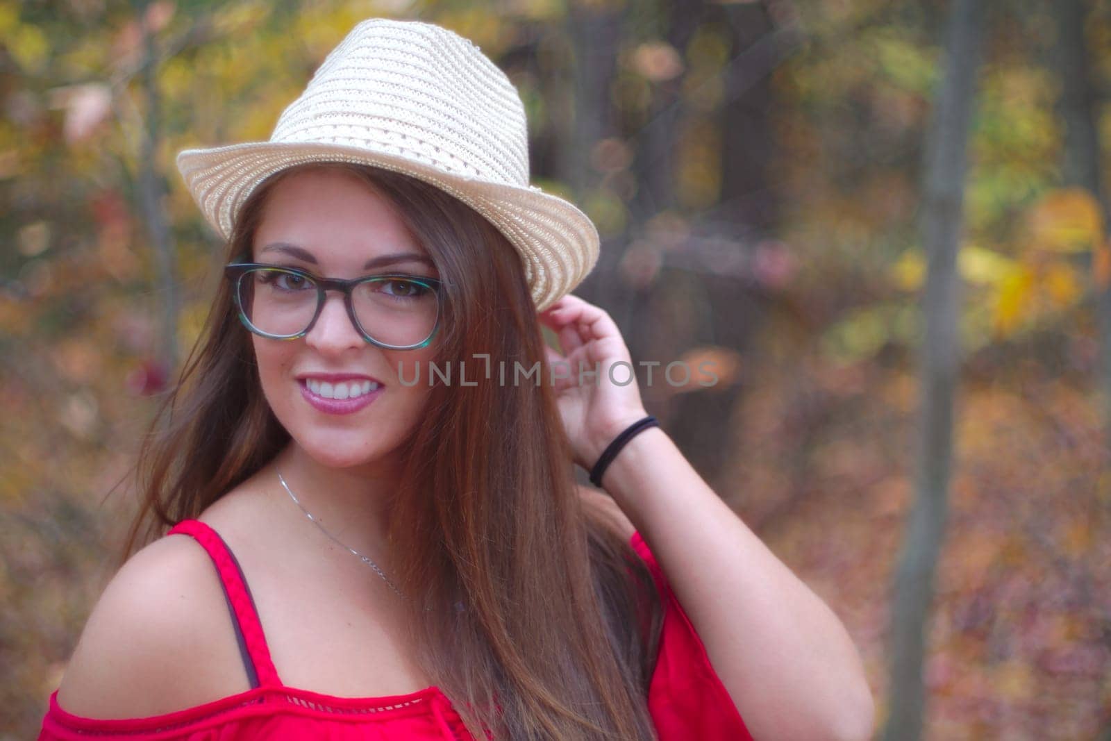 woman smiling hat red dress eyeglasses portrait outdoor autumn forest