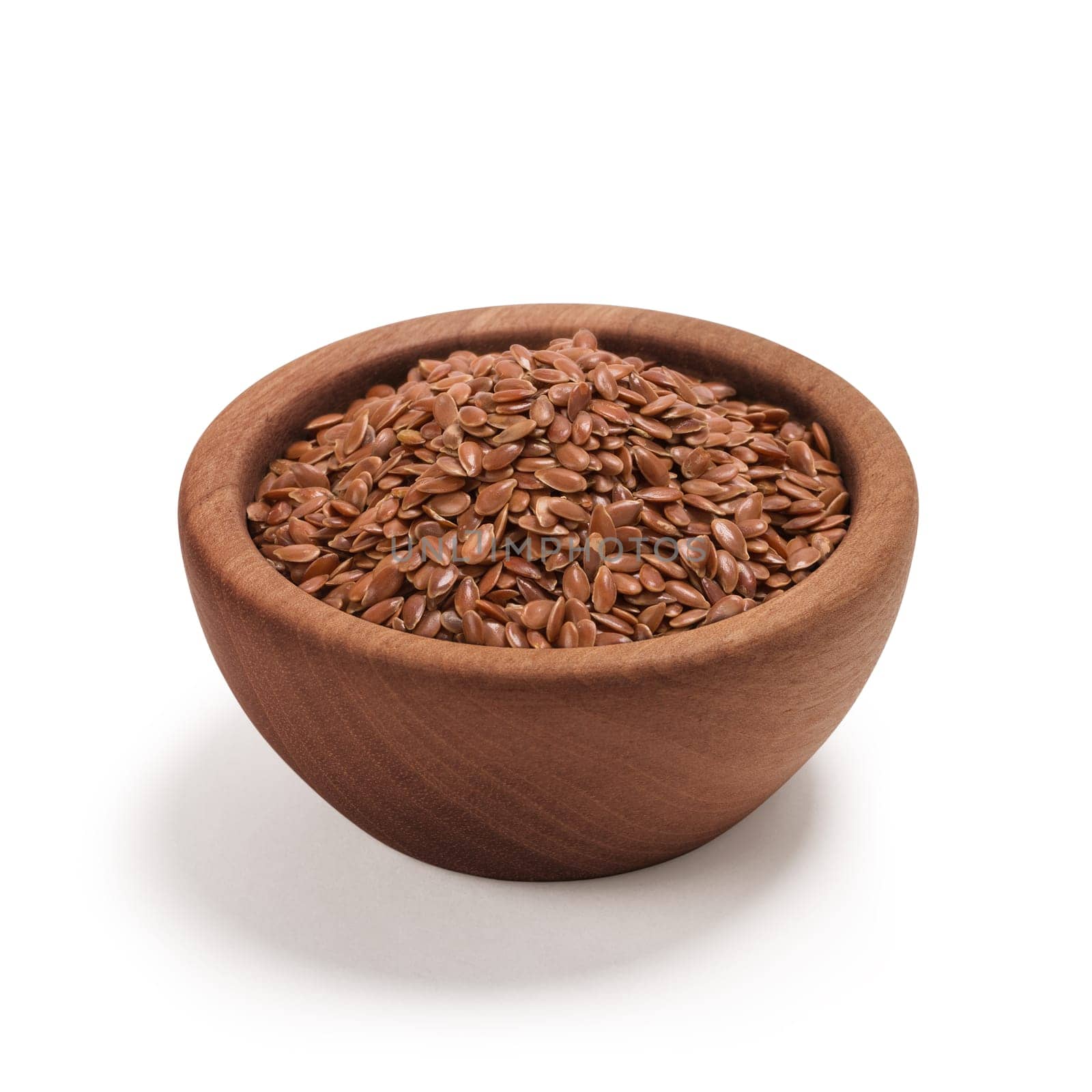 Ground or crushed brown flax seed or linseed in a wooden bowl, isolated