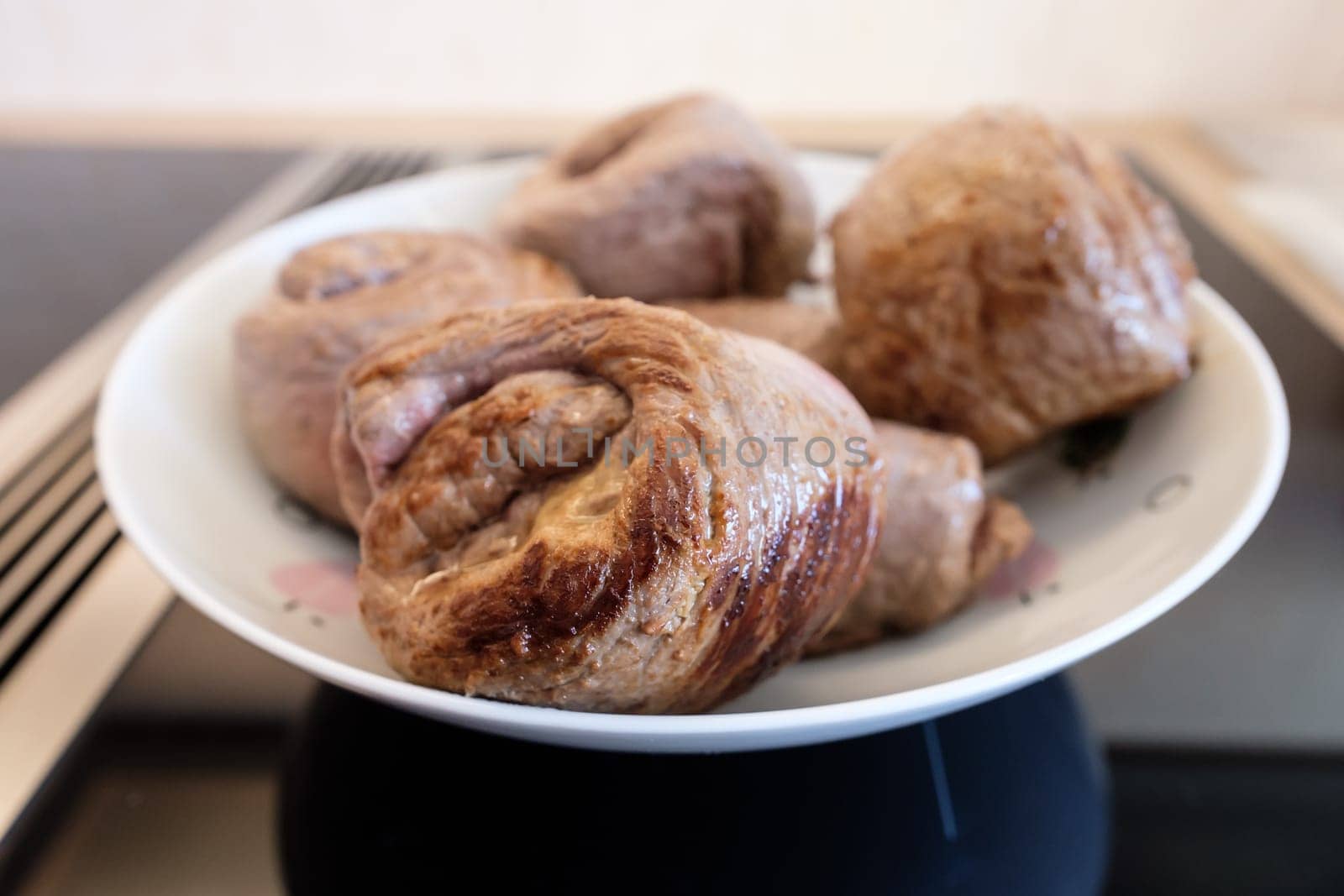 Roulade of beef fried on plate and stove