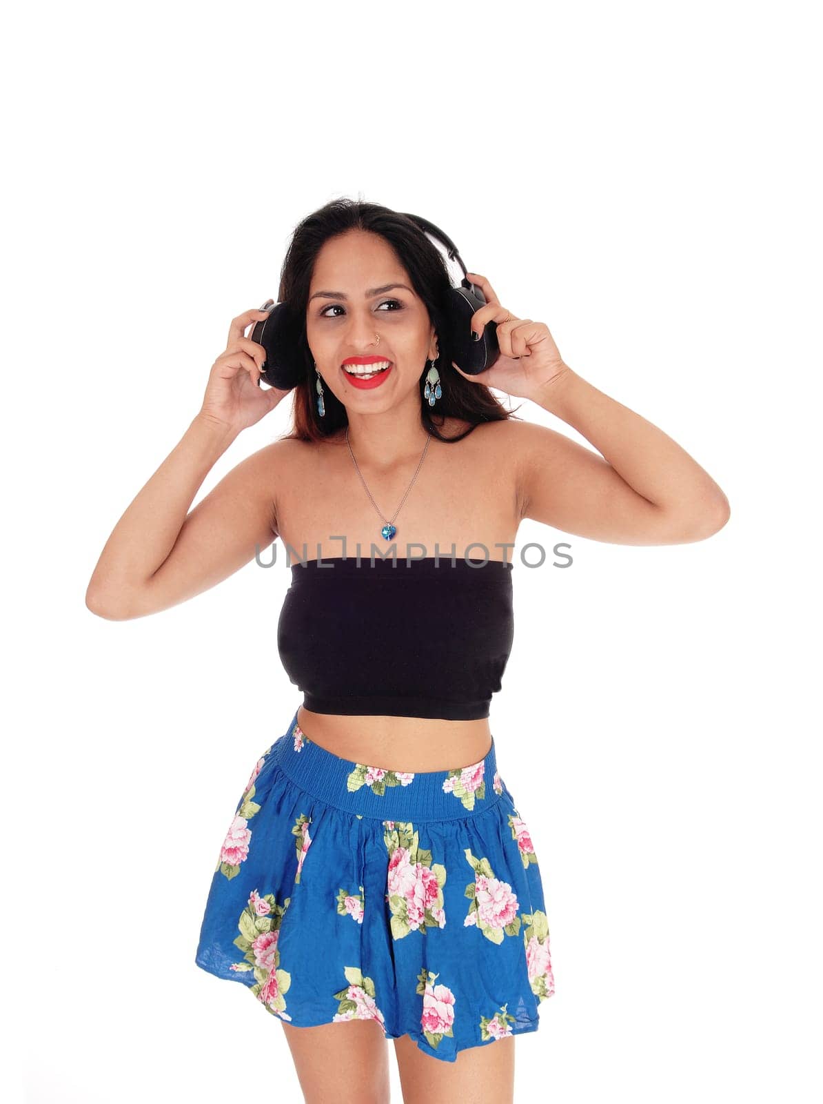 A beautiful happy woman with her headphone listening to music,.standing waist up, isolated for white background.