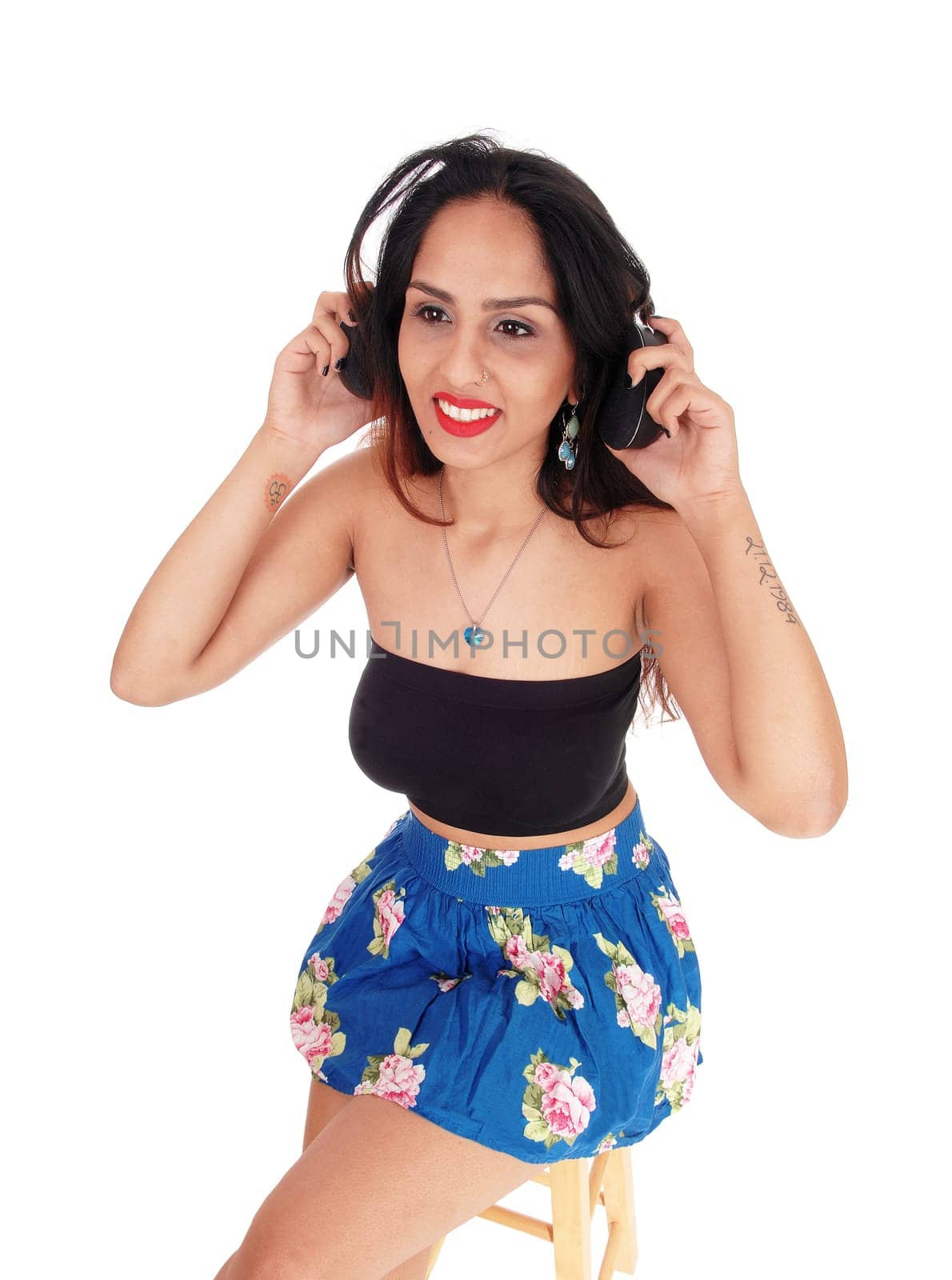 A beautiful happy woman with her headphone listening to music,.in an portrait image, isolated for white background.