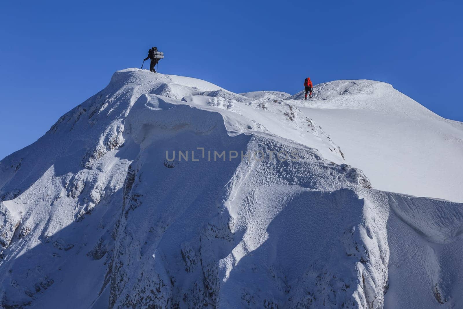 climbing on mountain in winter. Piatra Craiului Mountains, Romania