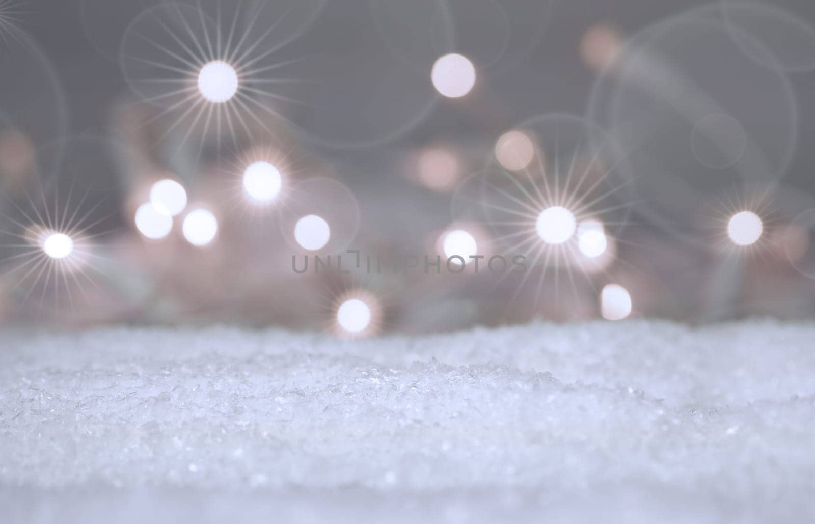 Christmas or seasonal background with snow and blurred lights