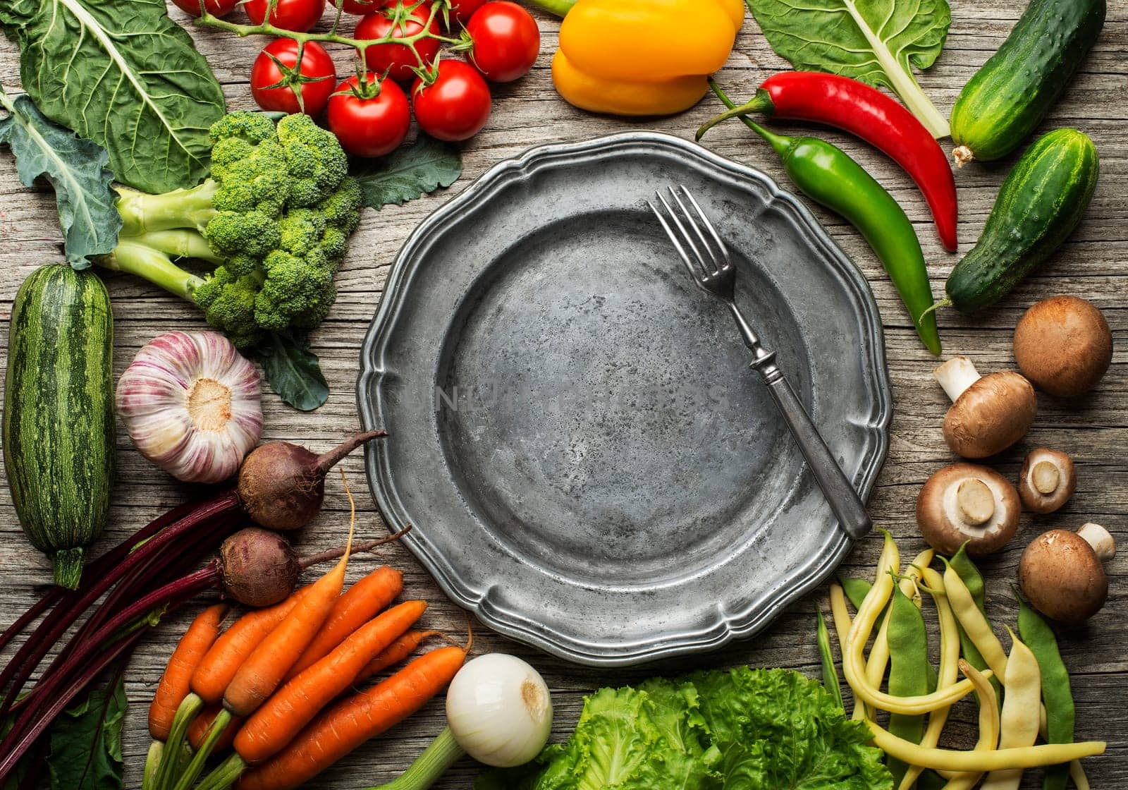 Various of fresh vegetables and ingredients with plate on wooden background. Healthy diet food concept
