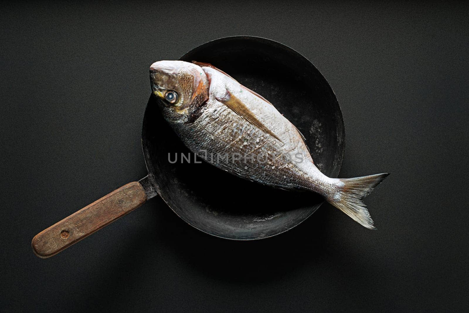 Delicious fresh fish on dark vintage background. Healthy food, diet or cooking concept