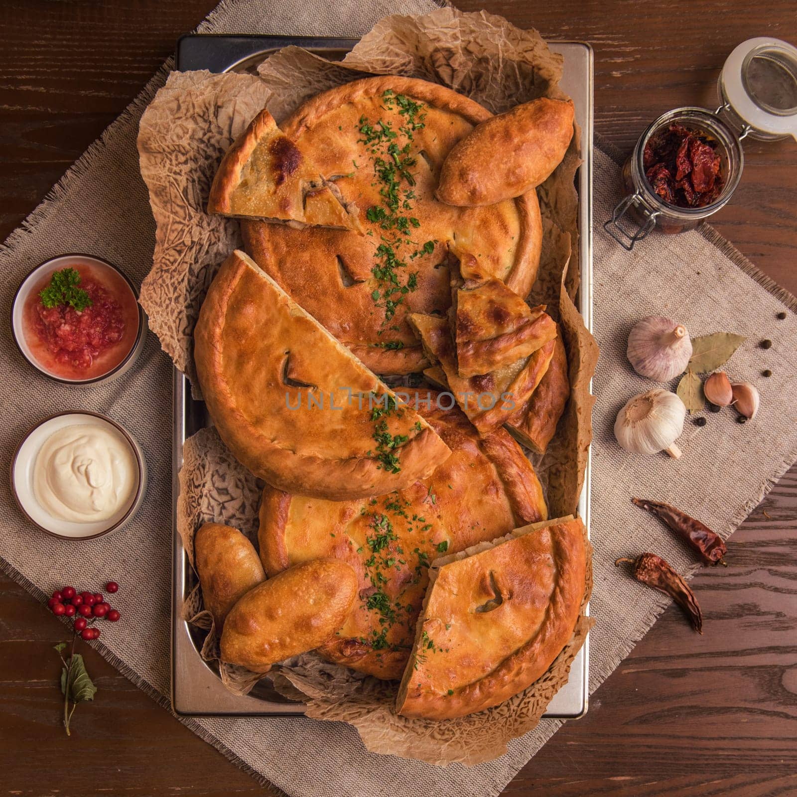 Different pies from meat and vegetables. Freshly baked cakes on a table