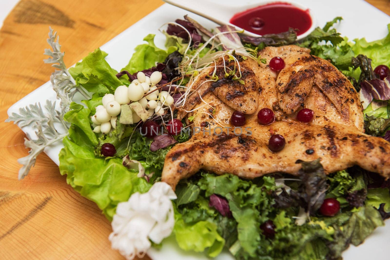 quail roasted with sweet and sour cranberry sauce decorated with rowanberry