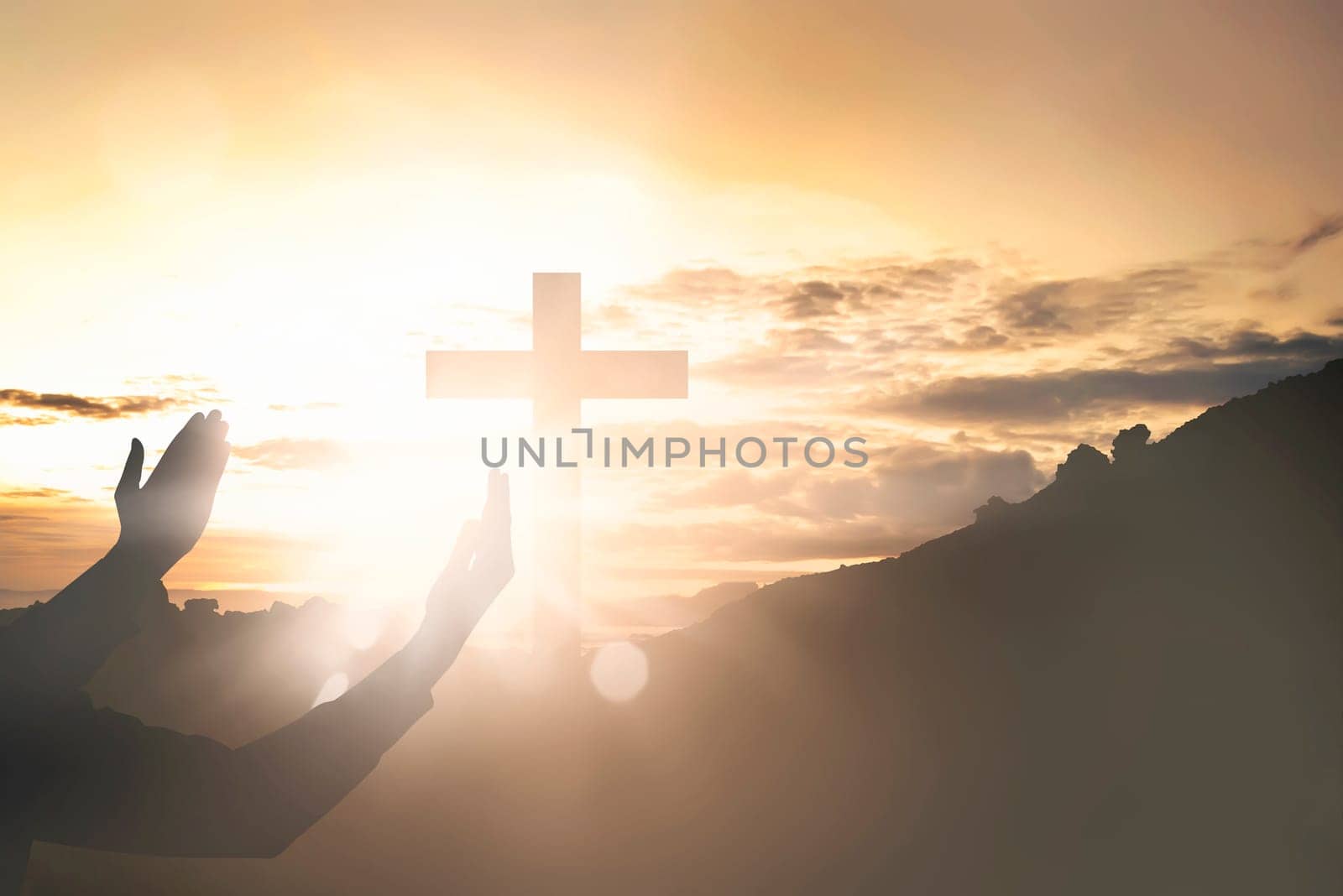 Human hands raising hand while praying to jesus on sunset background