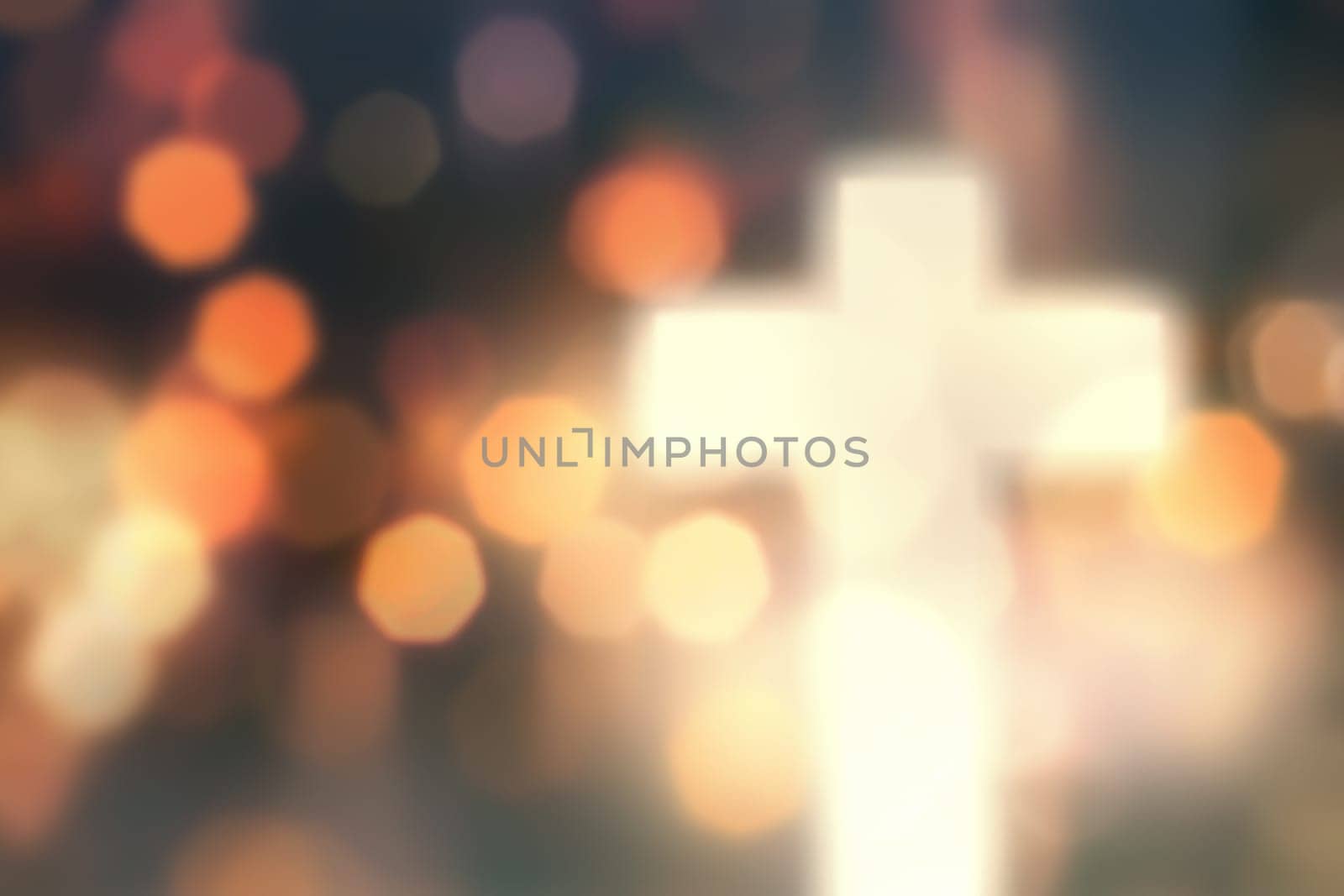 Defocused christian cross against light background