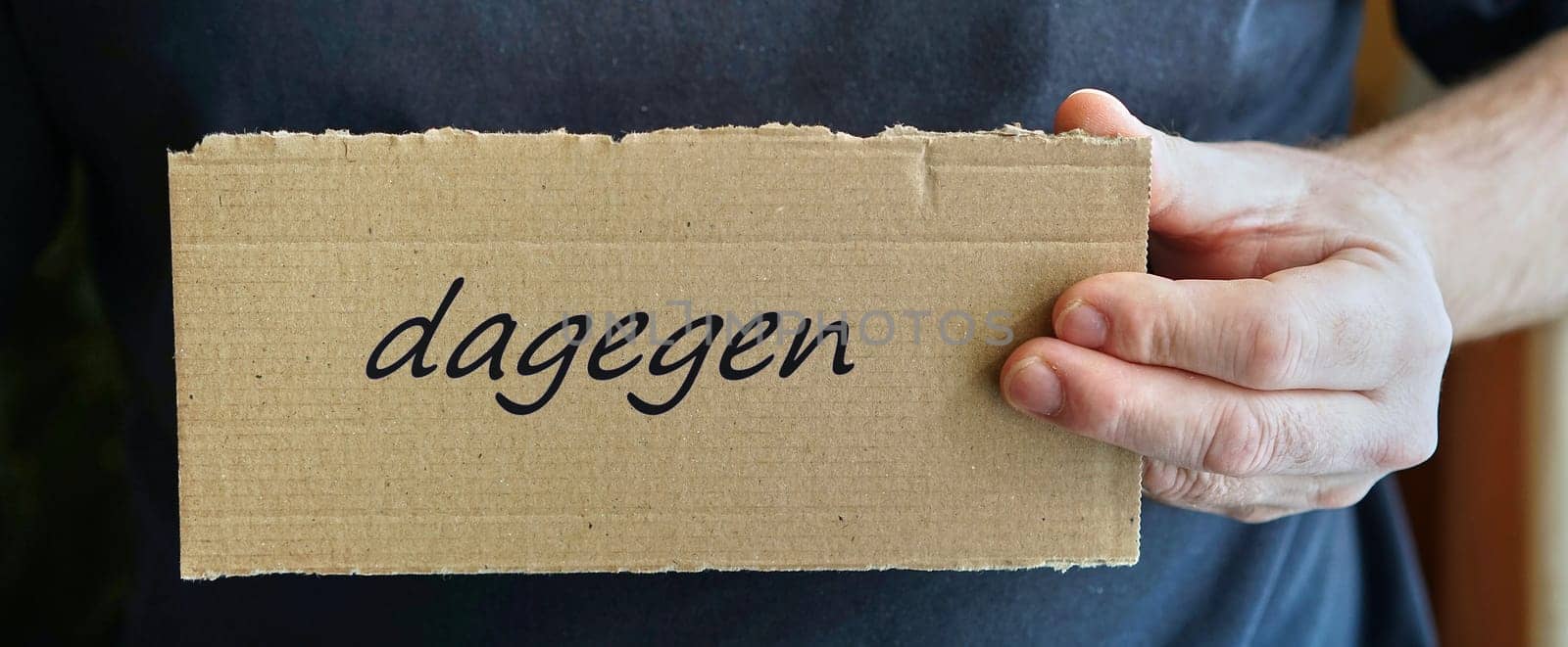 Cardboard sign with the inscription "against"""