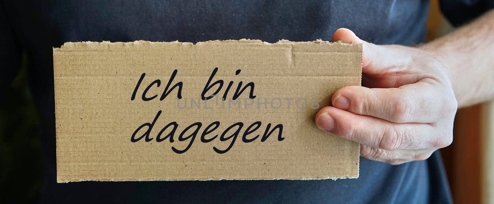 Cardboard sign with the inscription "I am against it"""