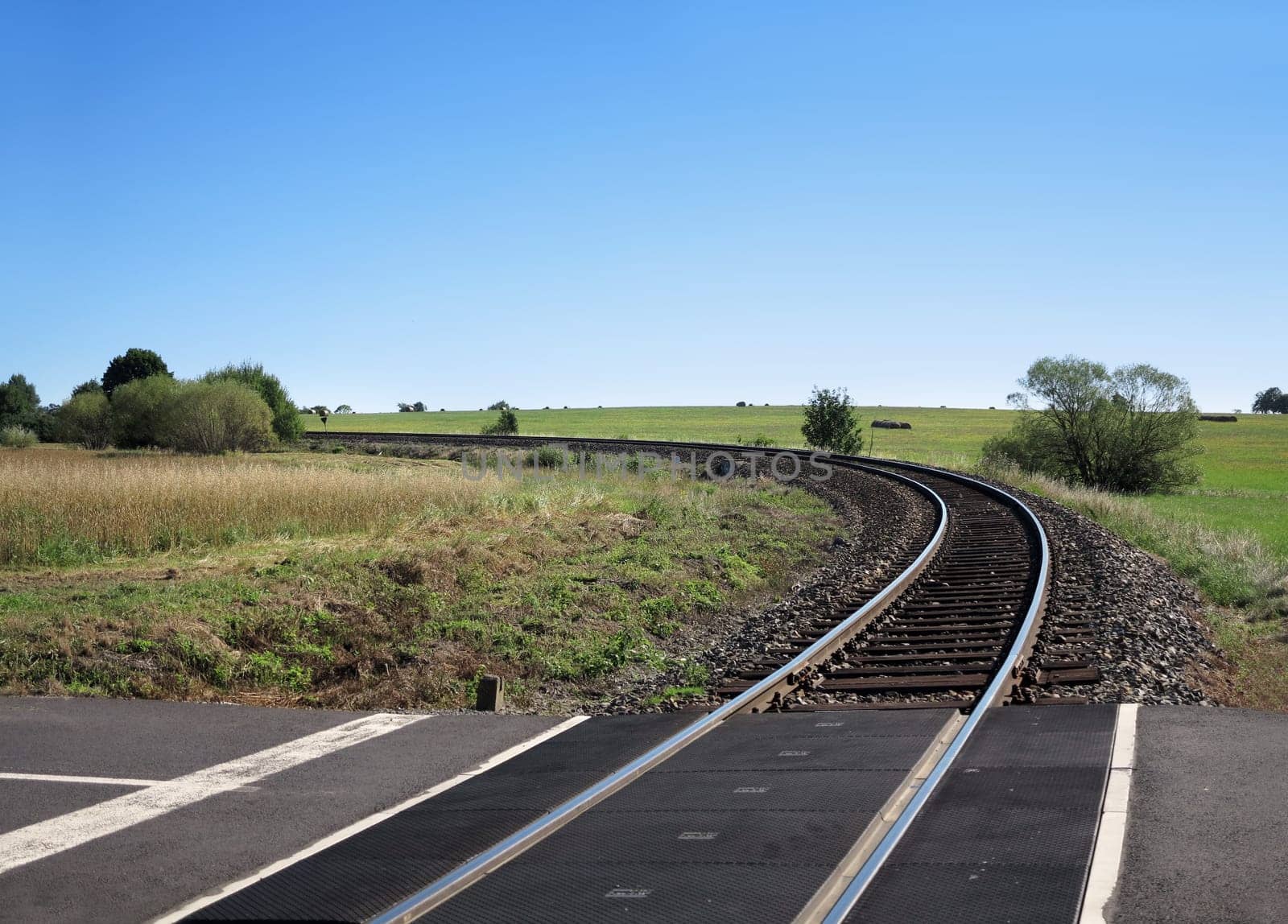 Empty track leading to the horizon with blue sky