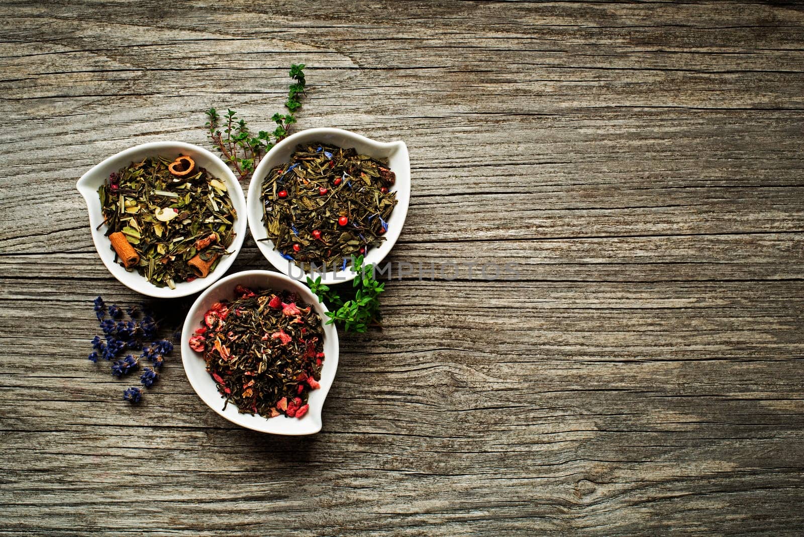Dry tea collection of different types on wooden background