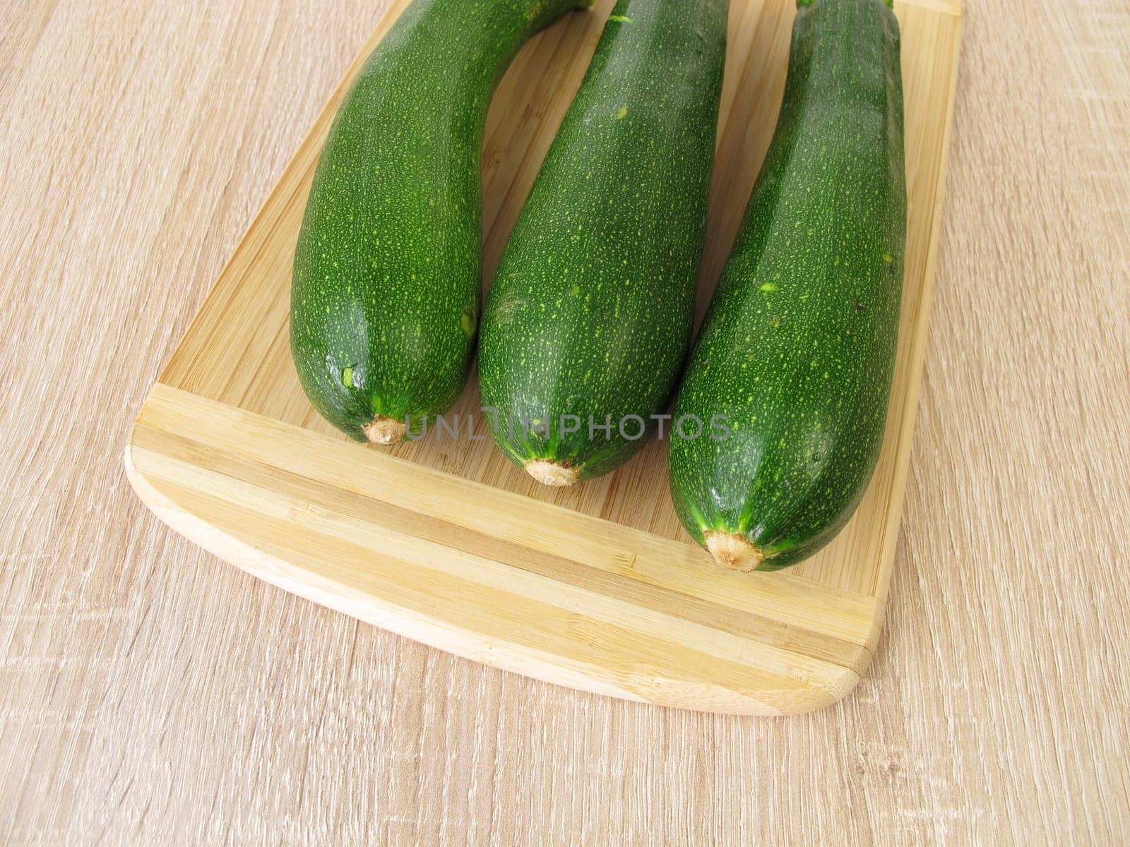 Green zucchini on a cutting board