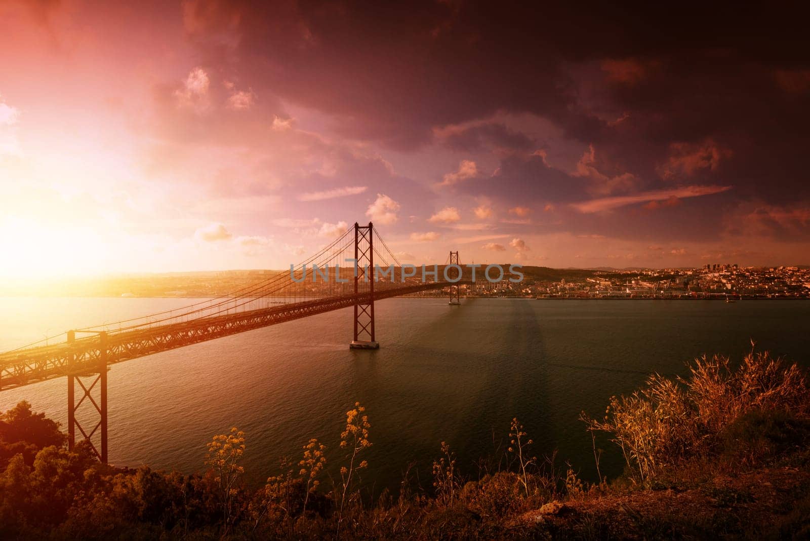 "25 de Abril"" bridge in Lisbon Portugal at sunset"