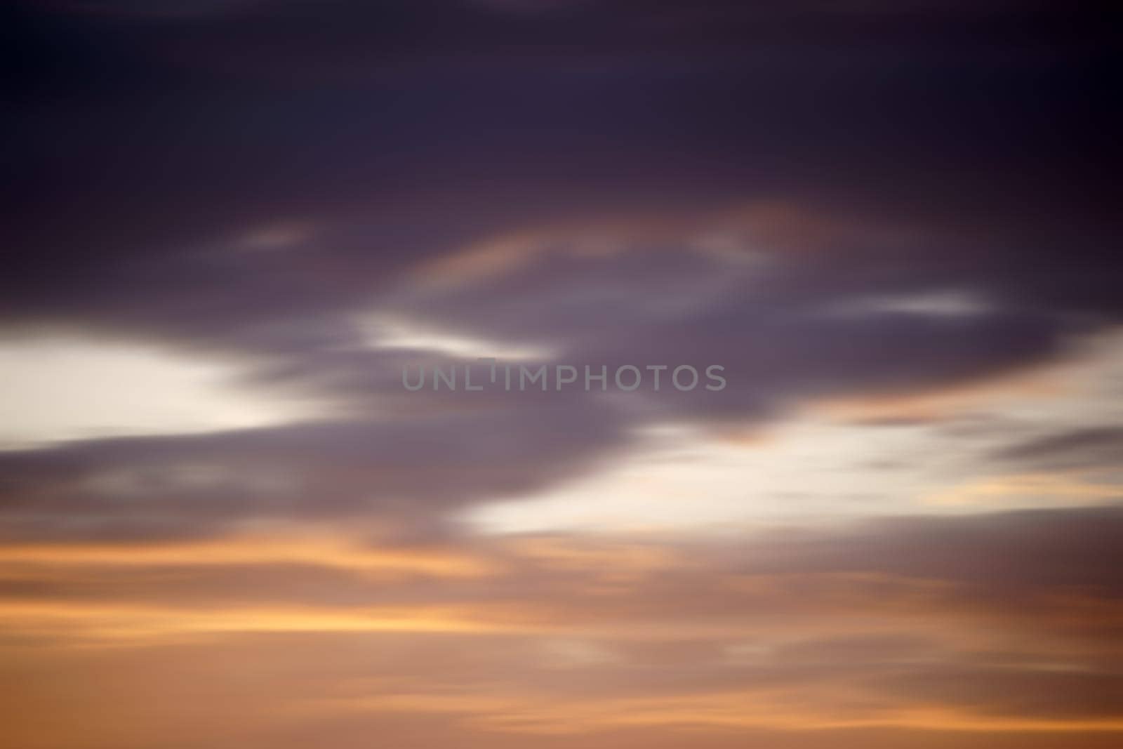 A blurred sky in the evening with colorful clouds.