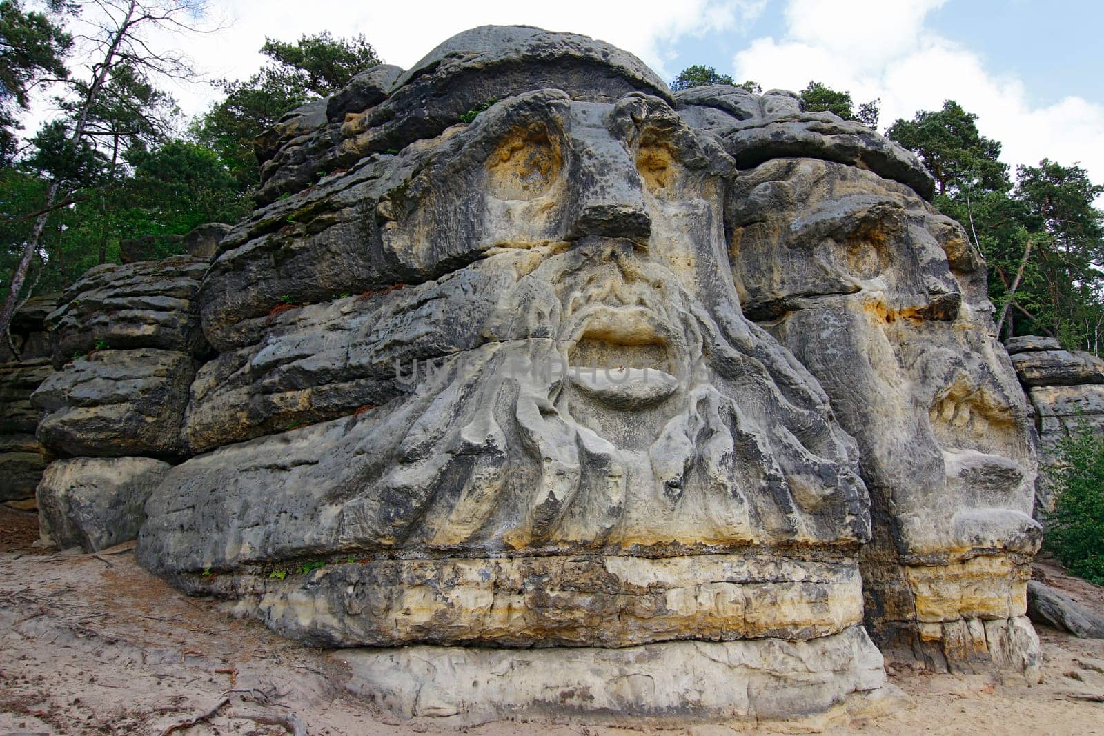 Heads of Devils are about 9 m high rock sculptures of giant heads carved into the sandstone cliffs in the pine forest above the village Zelizy in the district Melnik, Czech republic. It is the work of sculptor Vaclav Levy, who created in the period 1841-1846.