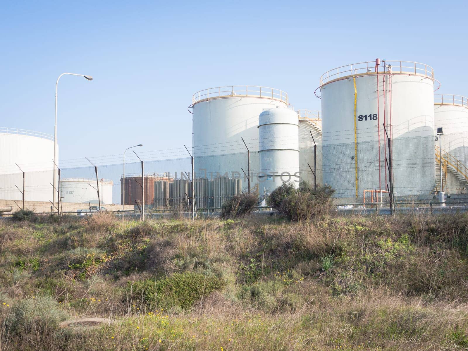 white industrial tanks in the industrial port of Oristano