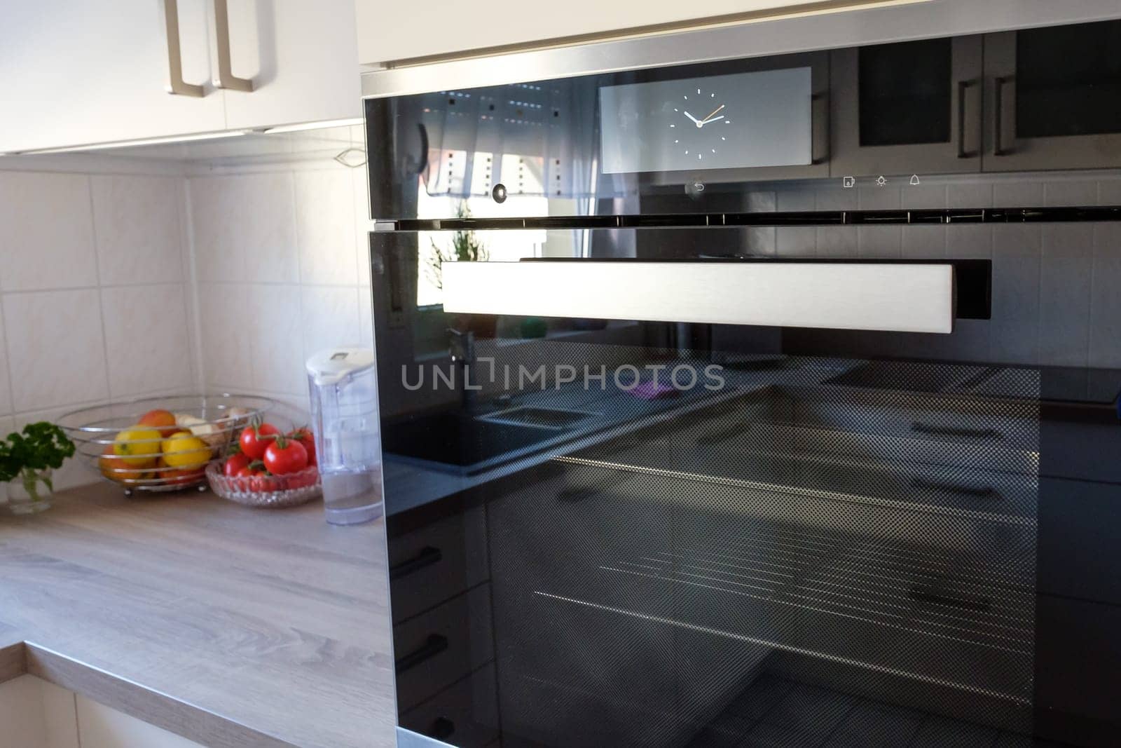 Oven with steamer in fitted kitchen with worktop