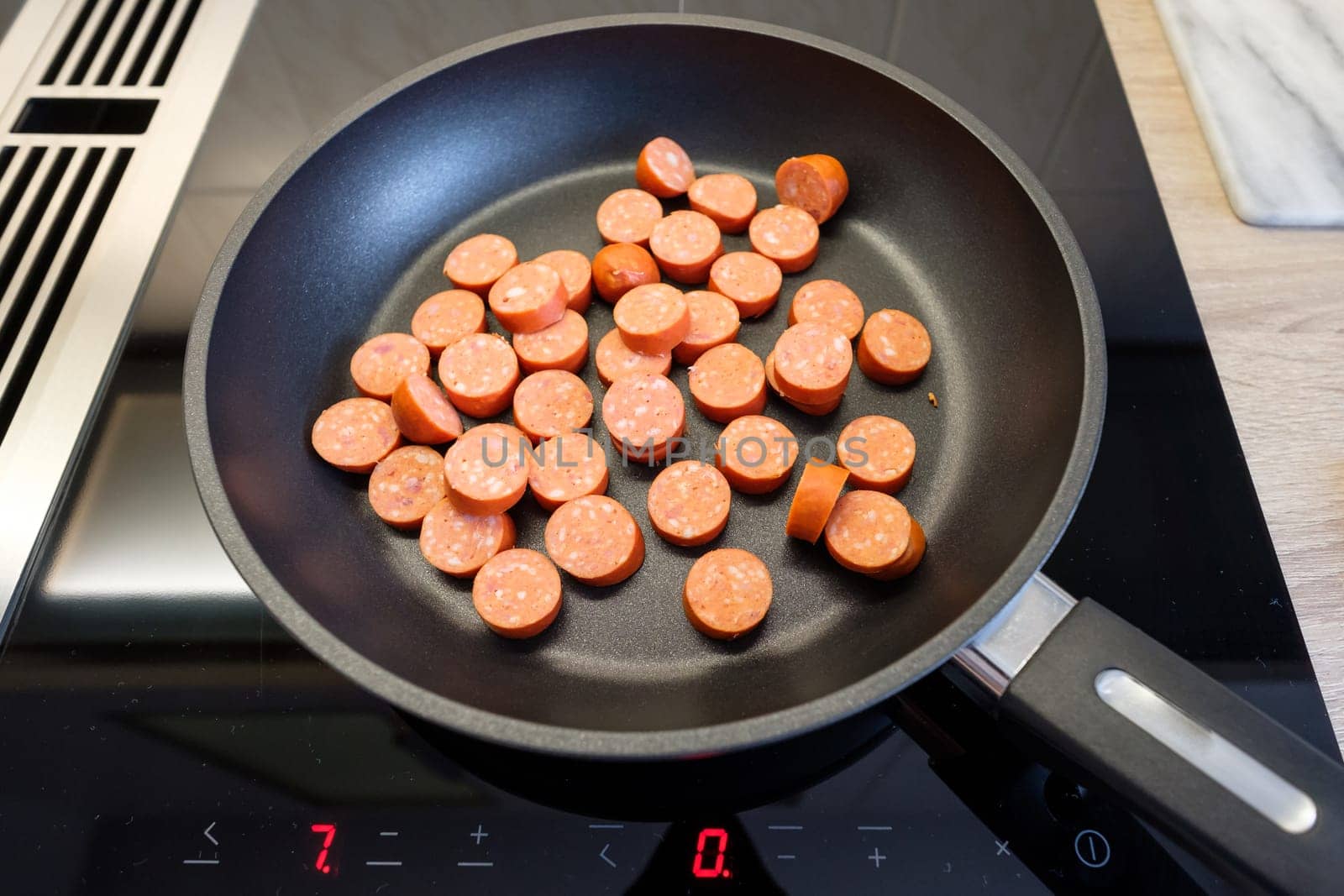 Sausage in slices in a frying pan on the stove