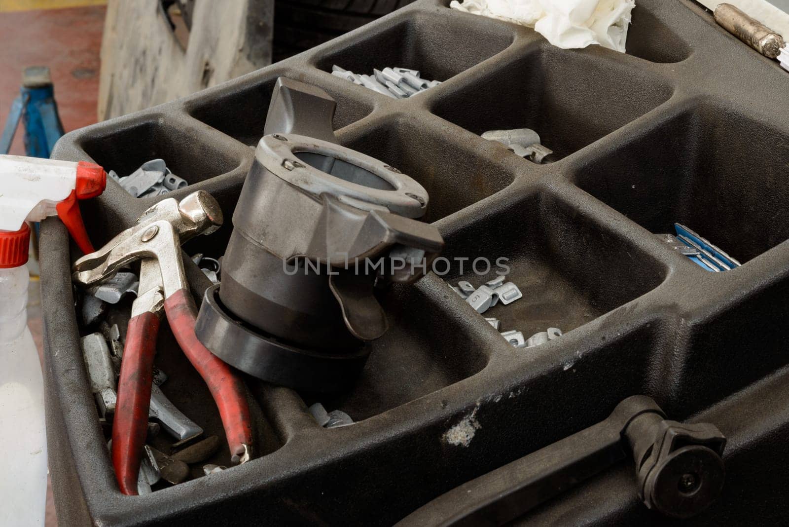 Various tools and stuff in a tire fix  workshop and a diplay of balancing machine