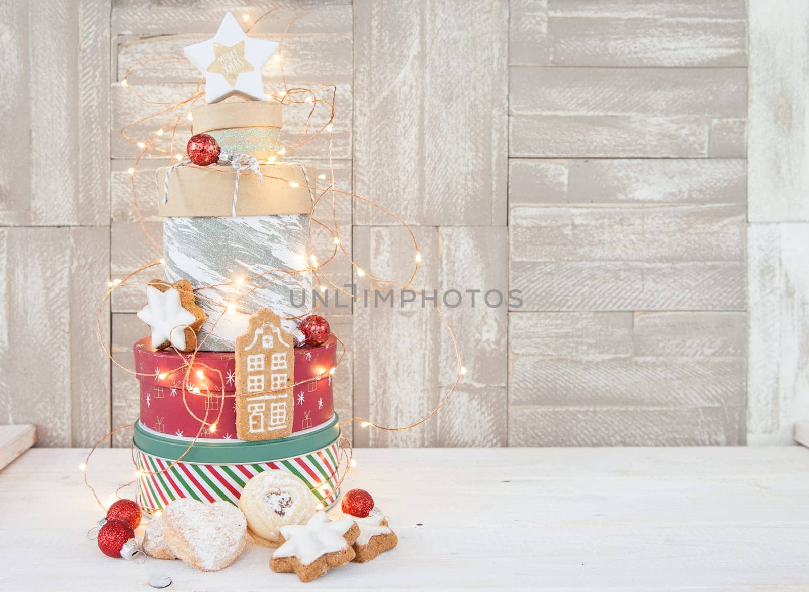 Various cookie jars with cookies stacked into a Christmas tree