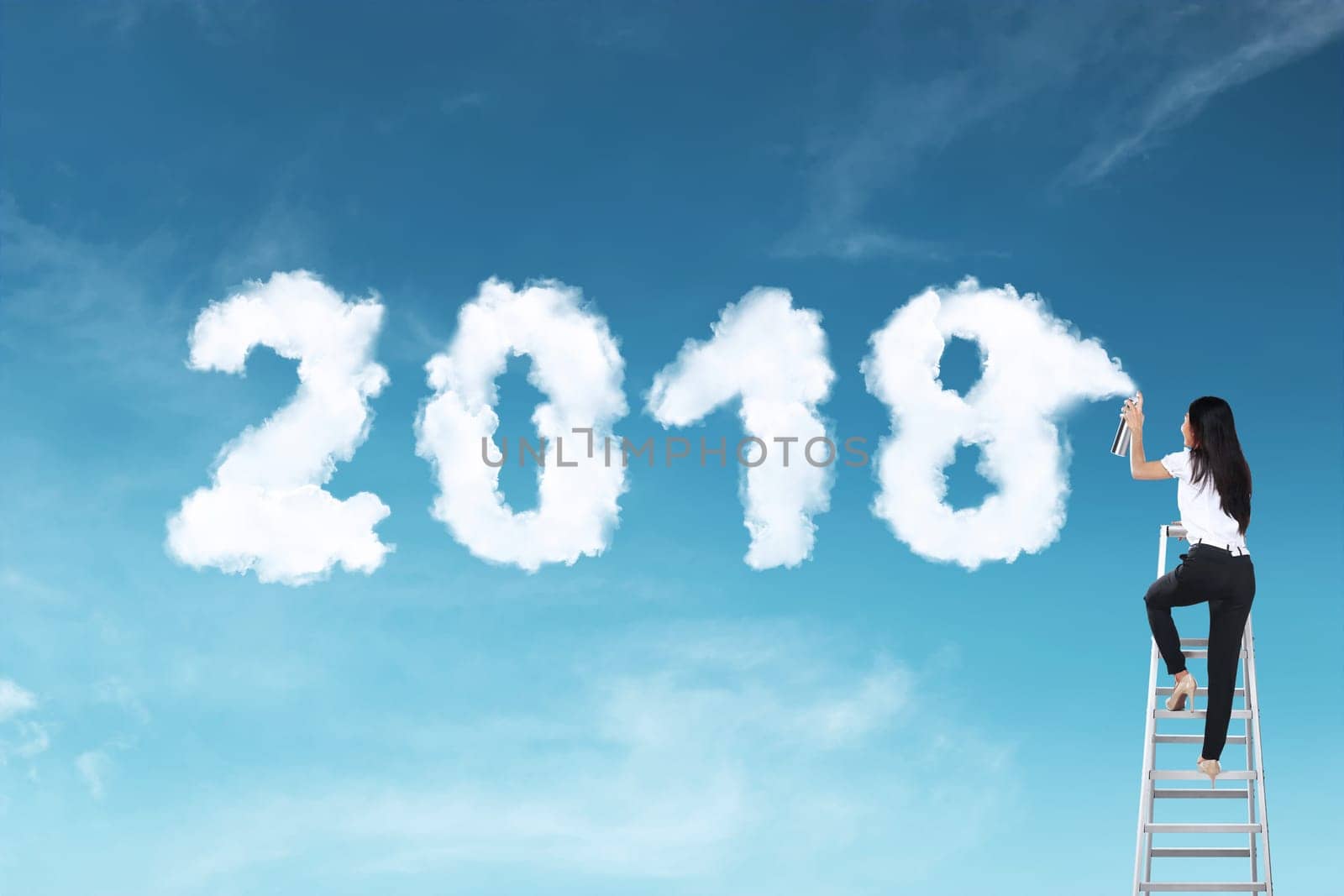 Business woman using stair spraying white cloud with 2018 shape on the sky