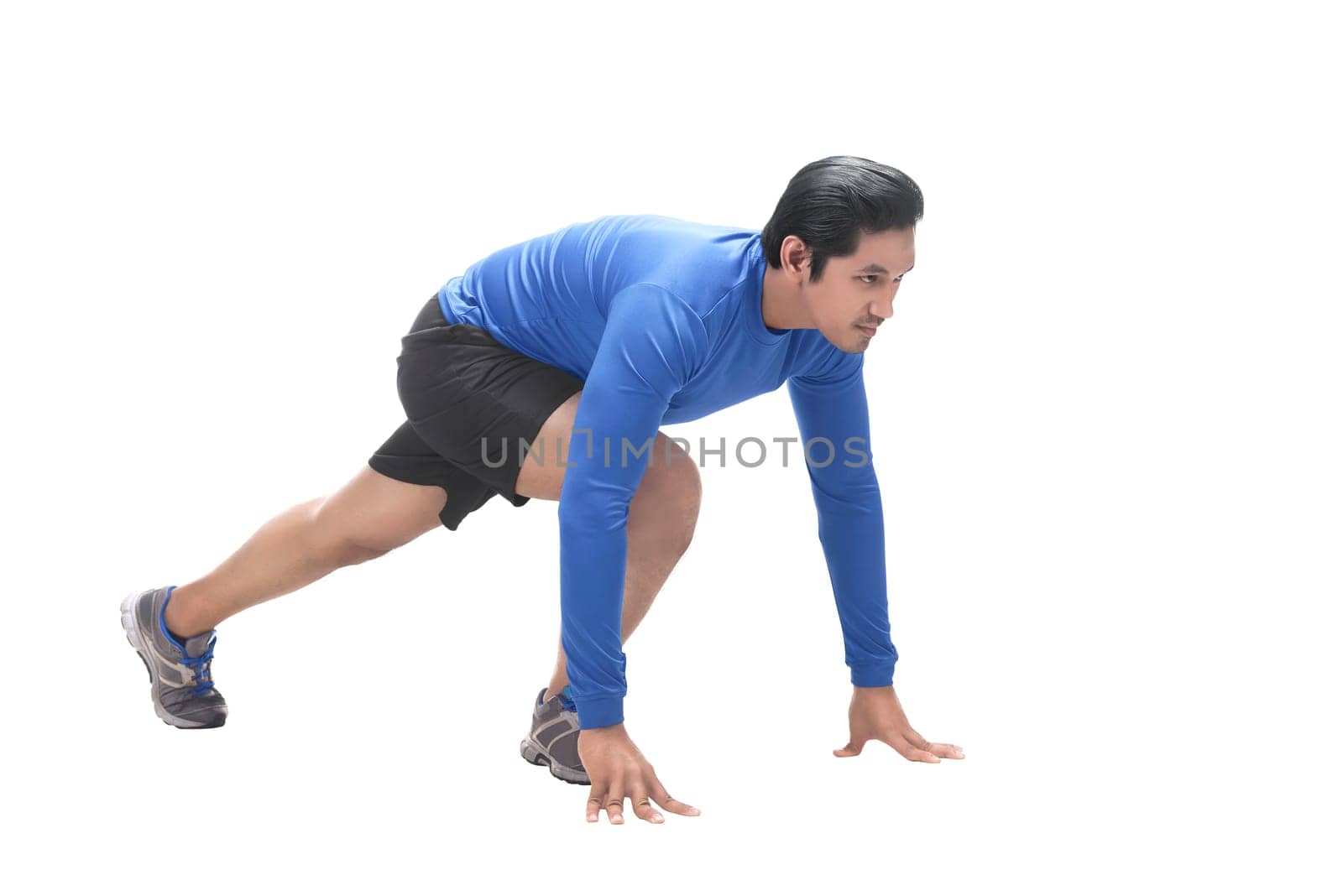Portrait of asian sportsman in ready position to run isolated over white background