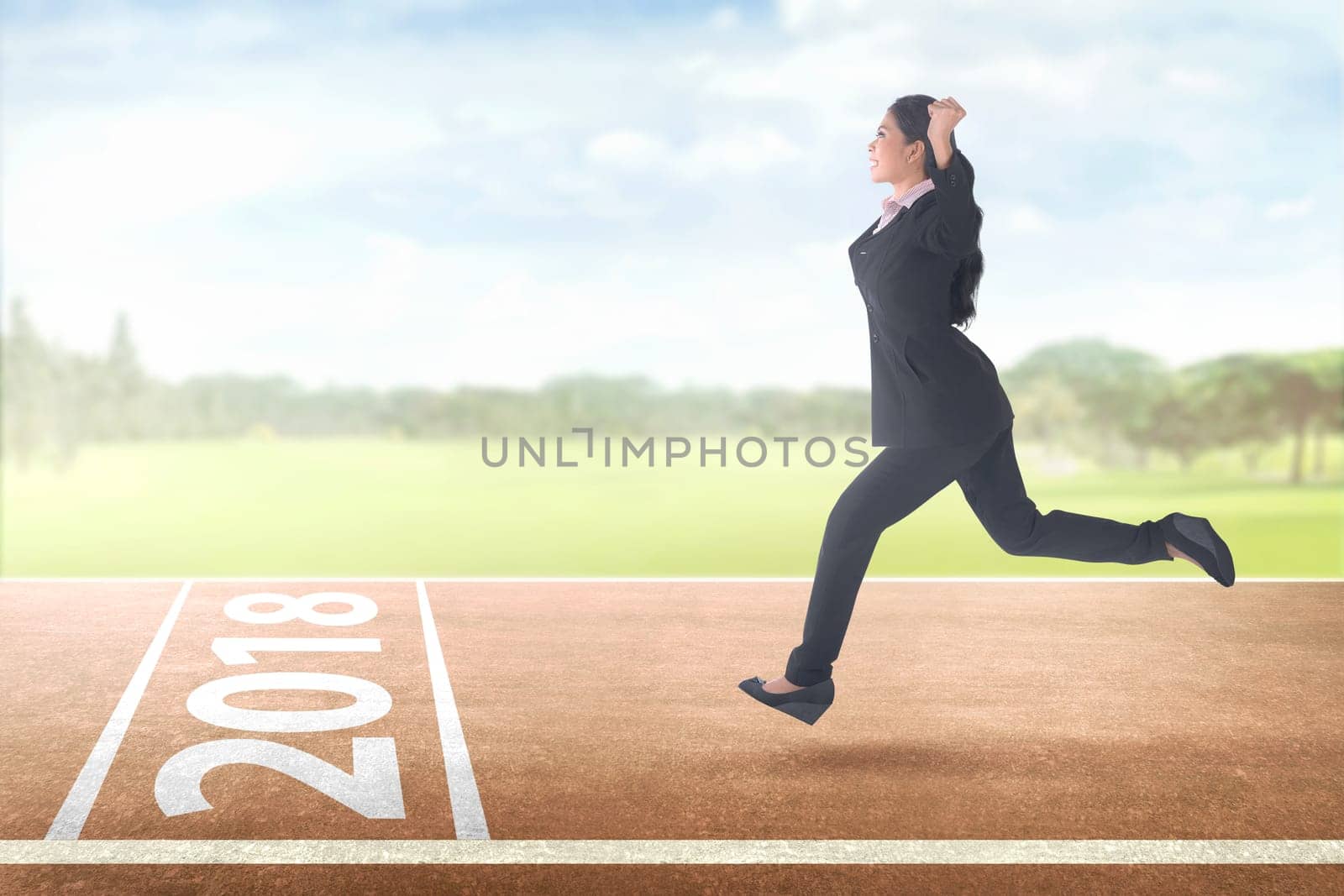 Happy asian business woman running with 2018 on finish line. Happy New Year 2018