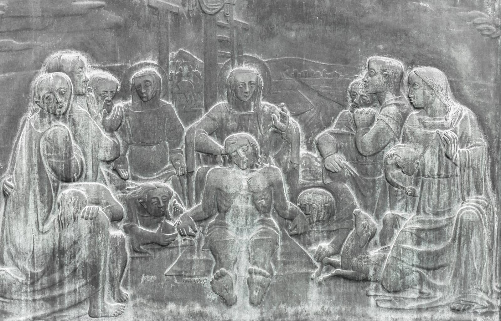 Stone wall engraving scene depicting the Lamentation of Christ