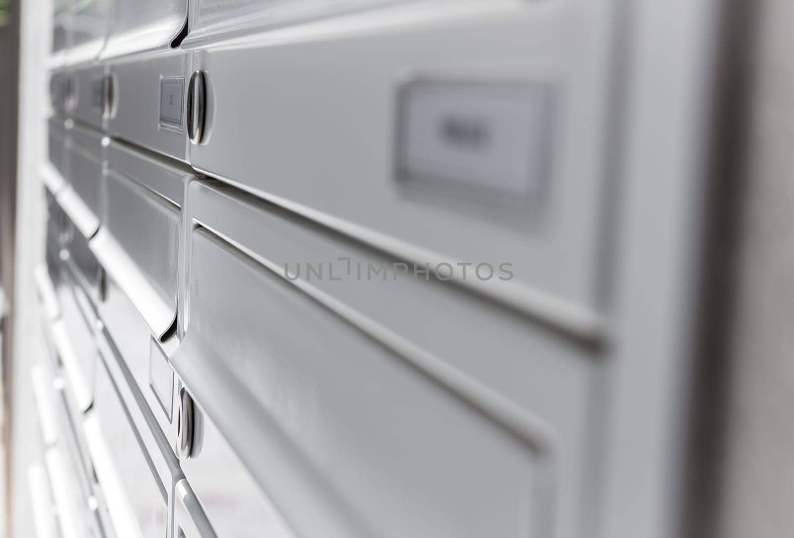 Rows of aluminum mail boxes for concepts such as safety and security, business communication and concepts. Shallow depth of field.