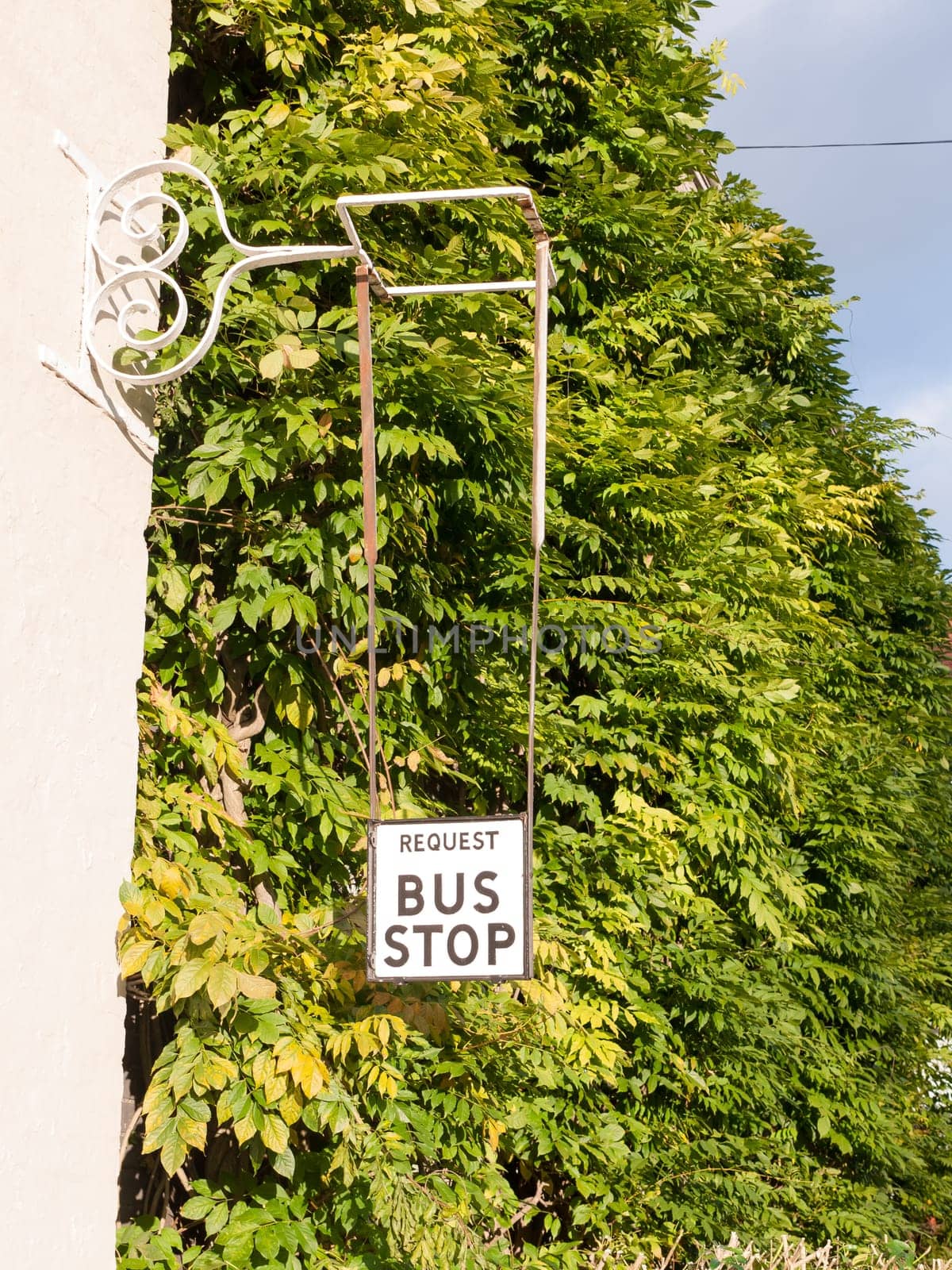 old fashioned retro request a bus stop sign  essex  england  uk