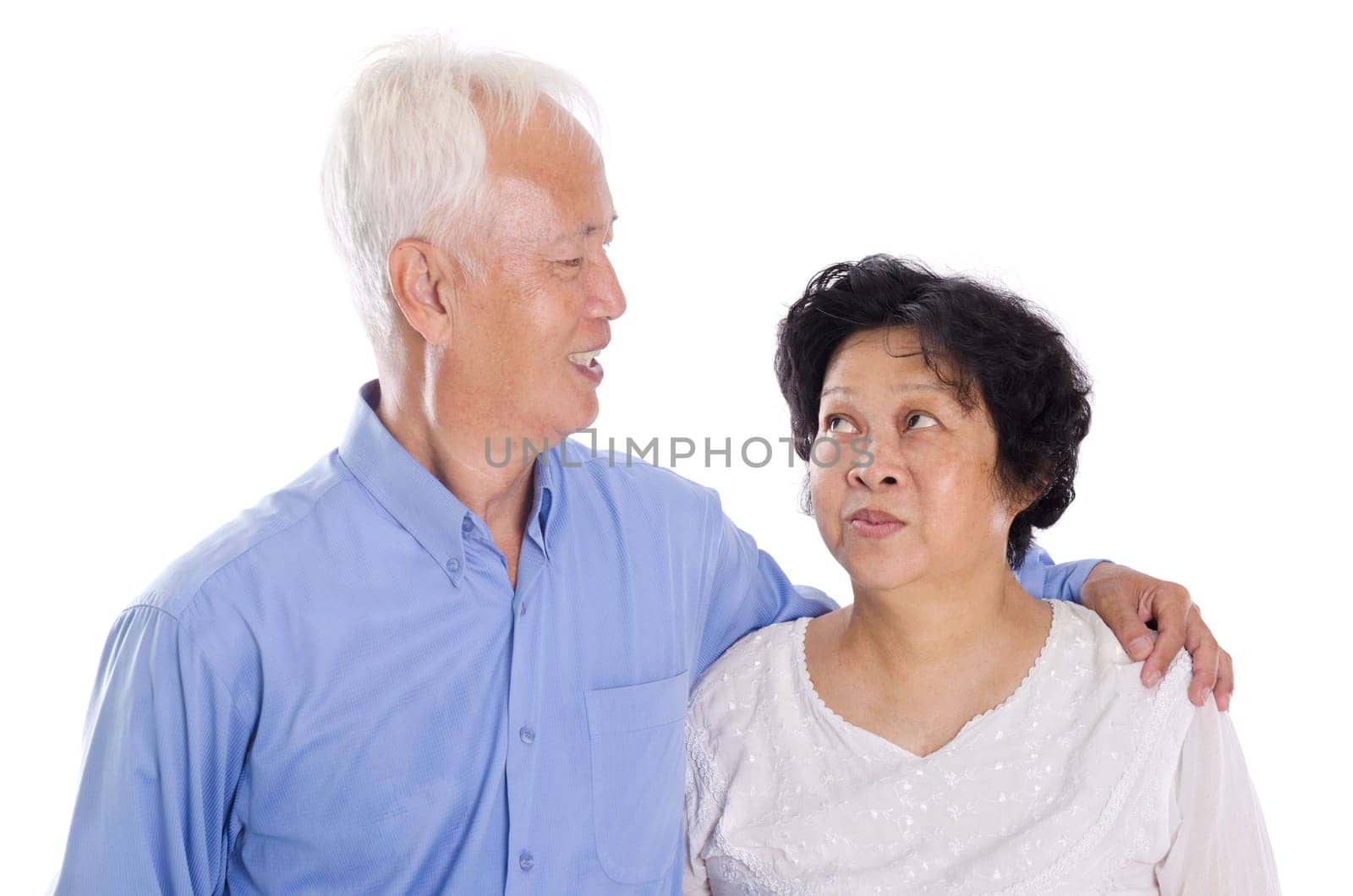Happy Asian elderly couple smiling,  standing isolated on white background.
