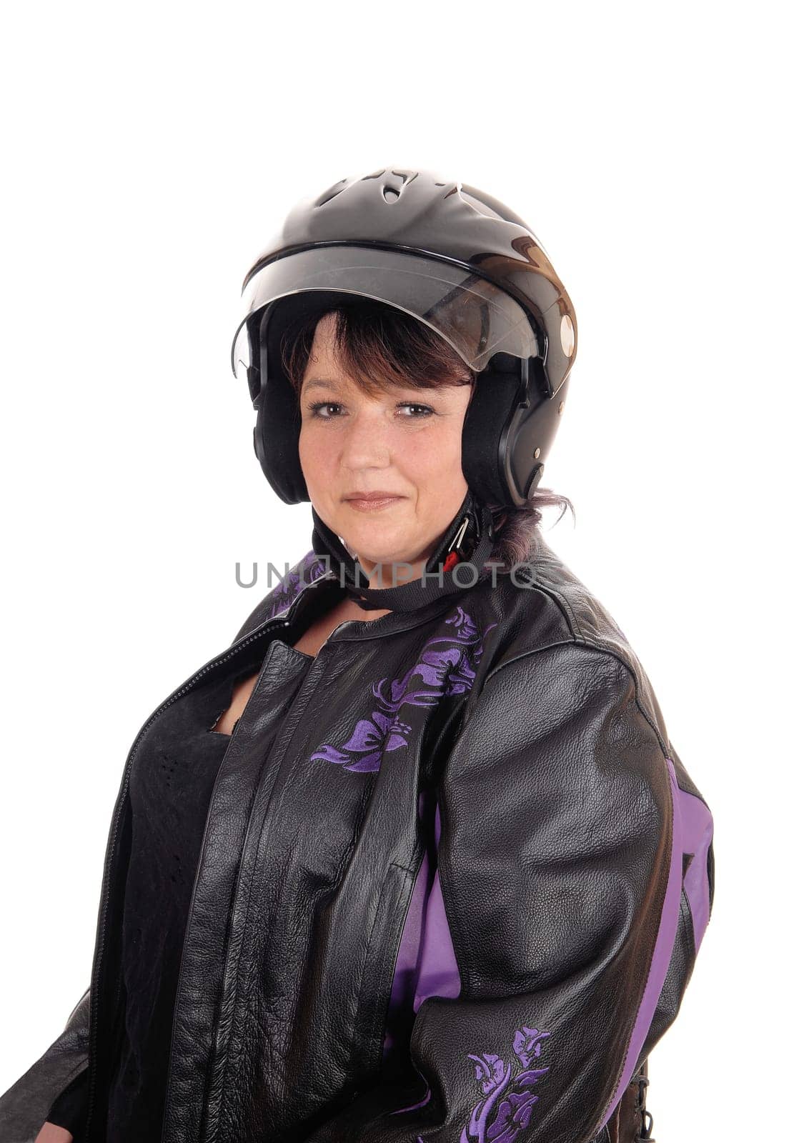 A beautiful full sized woman wearing a motorcycle helmet and black.leather jacket sitting isolated for white background.