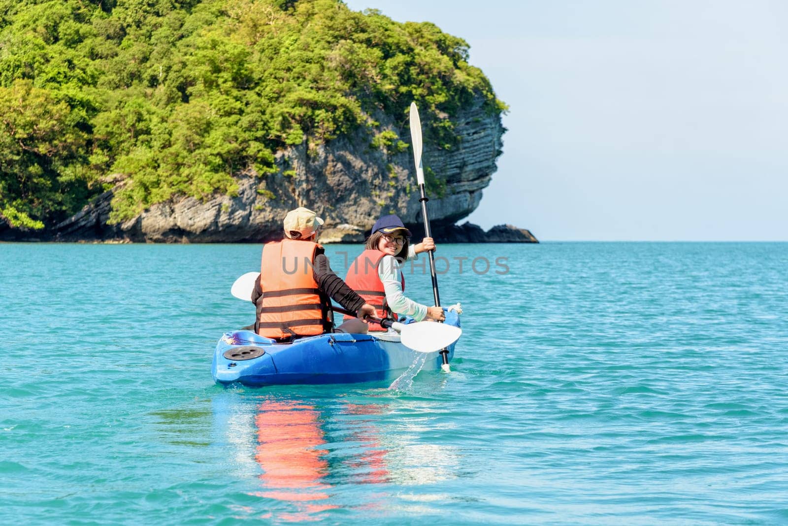 Two women are mother and daughter. Travel by boat with a kayak happy on the sea under the bright summer sky front of Ko Wua Ta lap islands at Mu Ko Ang Thong National Park, Surat Thani, Thailand