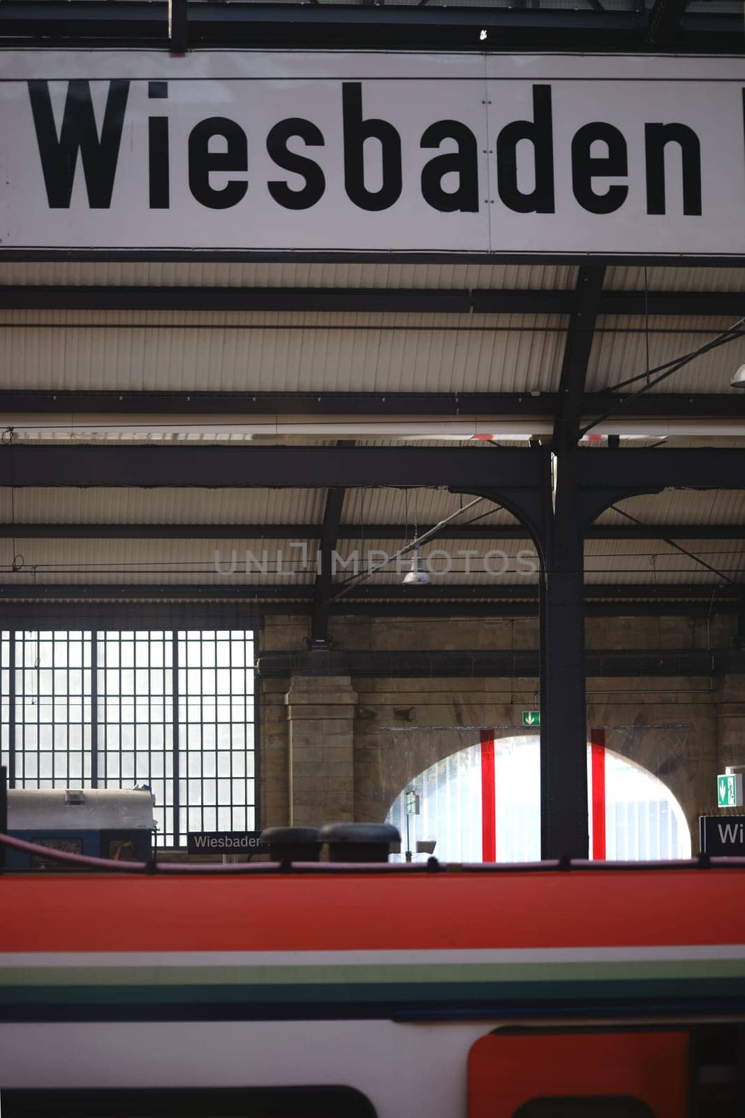 Wiesbaden,Germany - October 15,2017: The sign Wiesbaden Hauptbahnhof below the roof structure of the building on October 15,2017 in Wiesbaden.