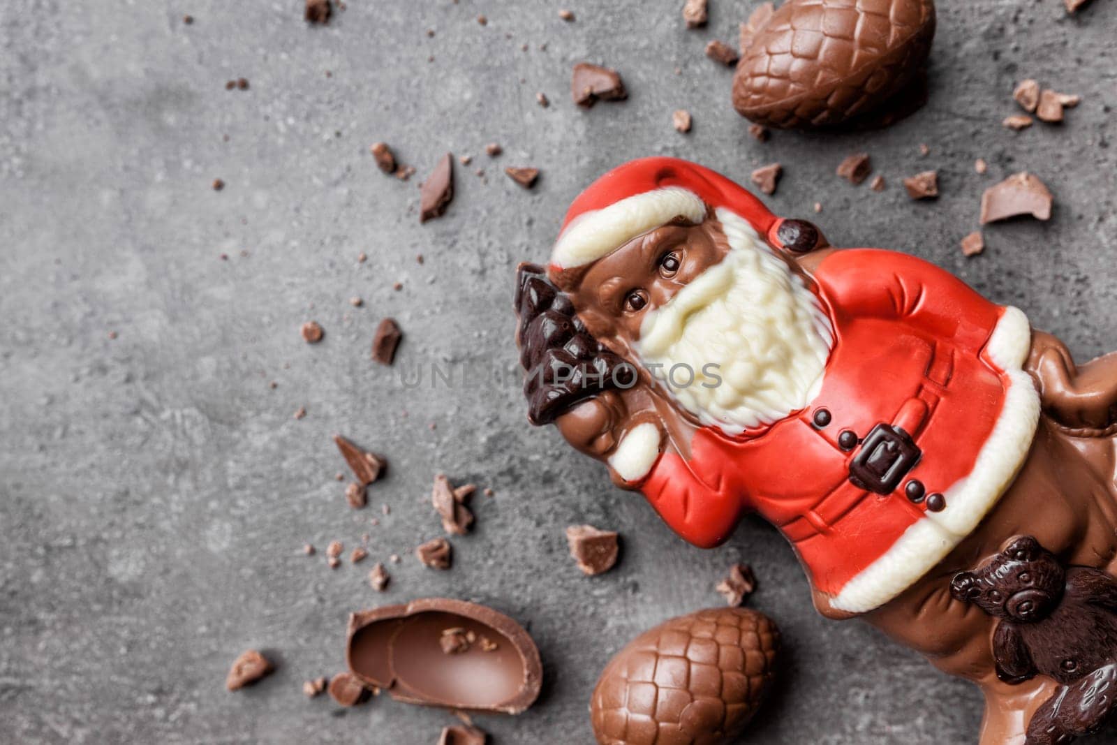 Delicious festive Christmas chocolate and sweets on rustic background