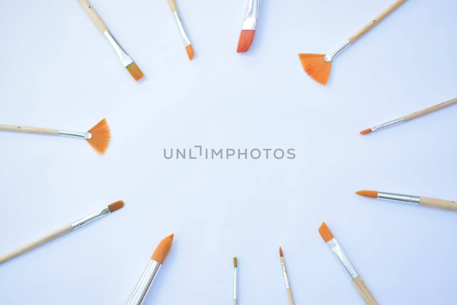 artists paint brushes arranged in a circle giving space for centred content