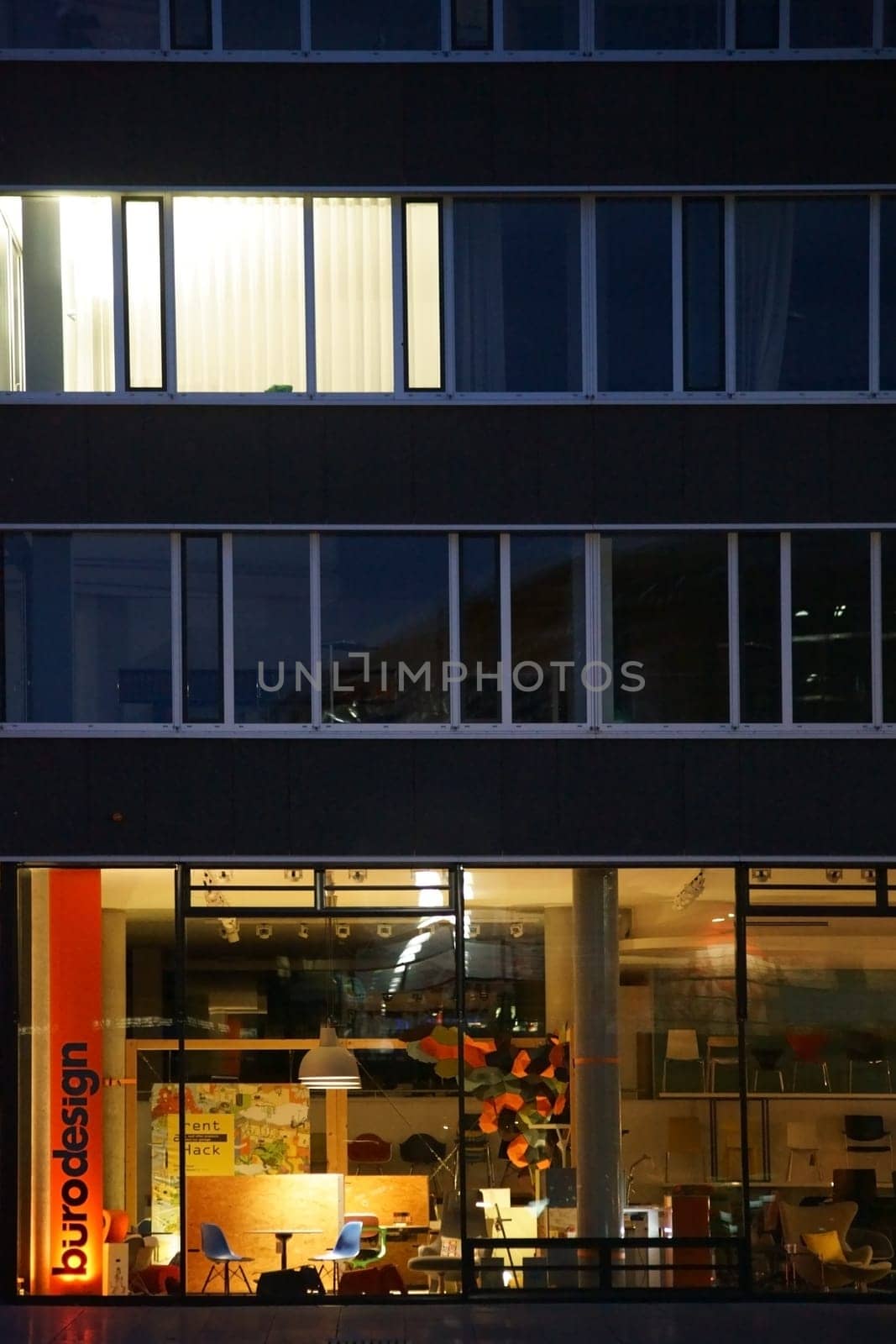 Darmstadt,Germany - October 31,2017: A neon-lit office design store at night at the train station on October 31,2017 in Darmstadt.