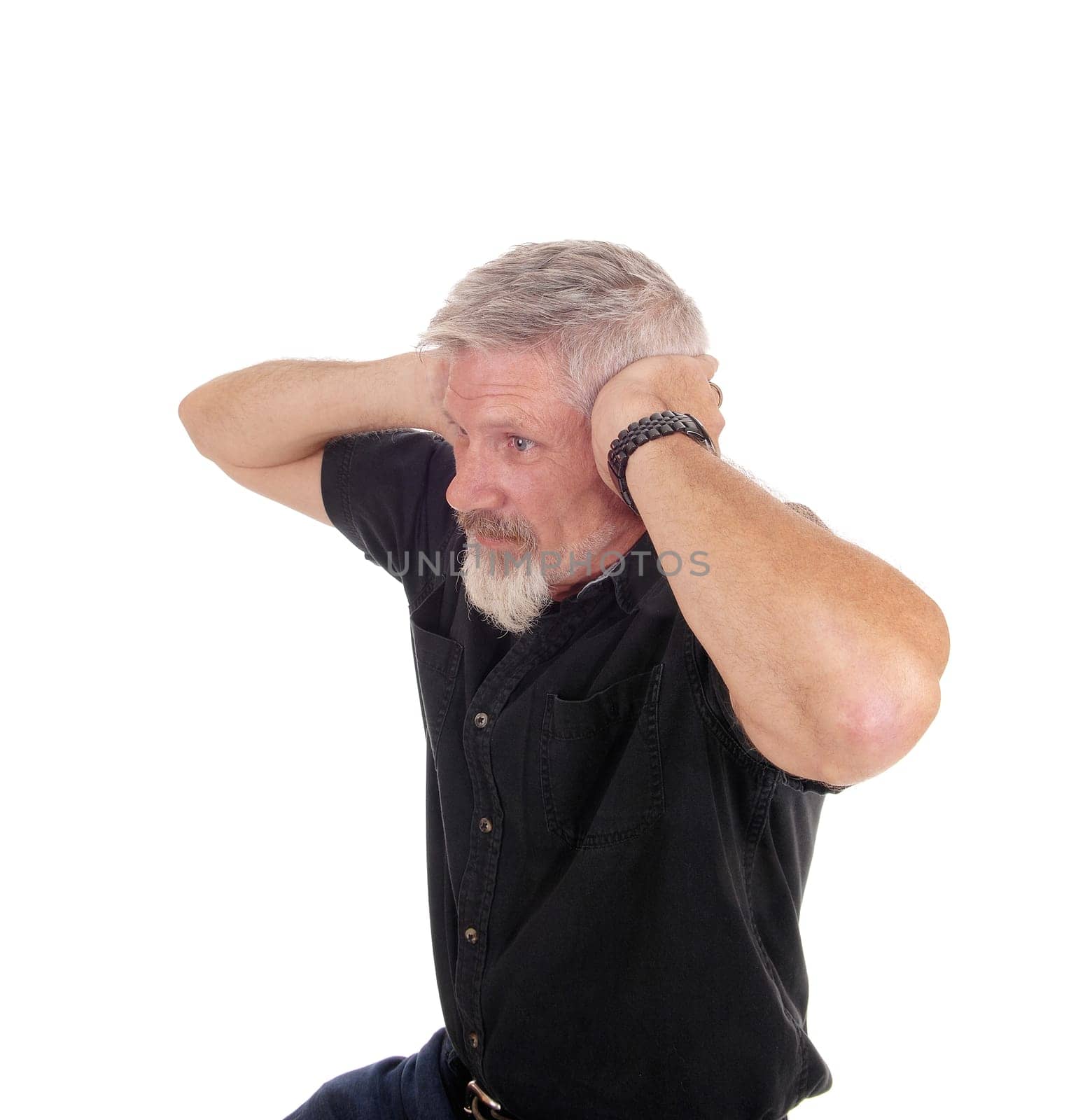 A middle age man with gray hair and beard sitting and holding his hands.over his ears, isolated for white background.